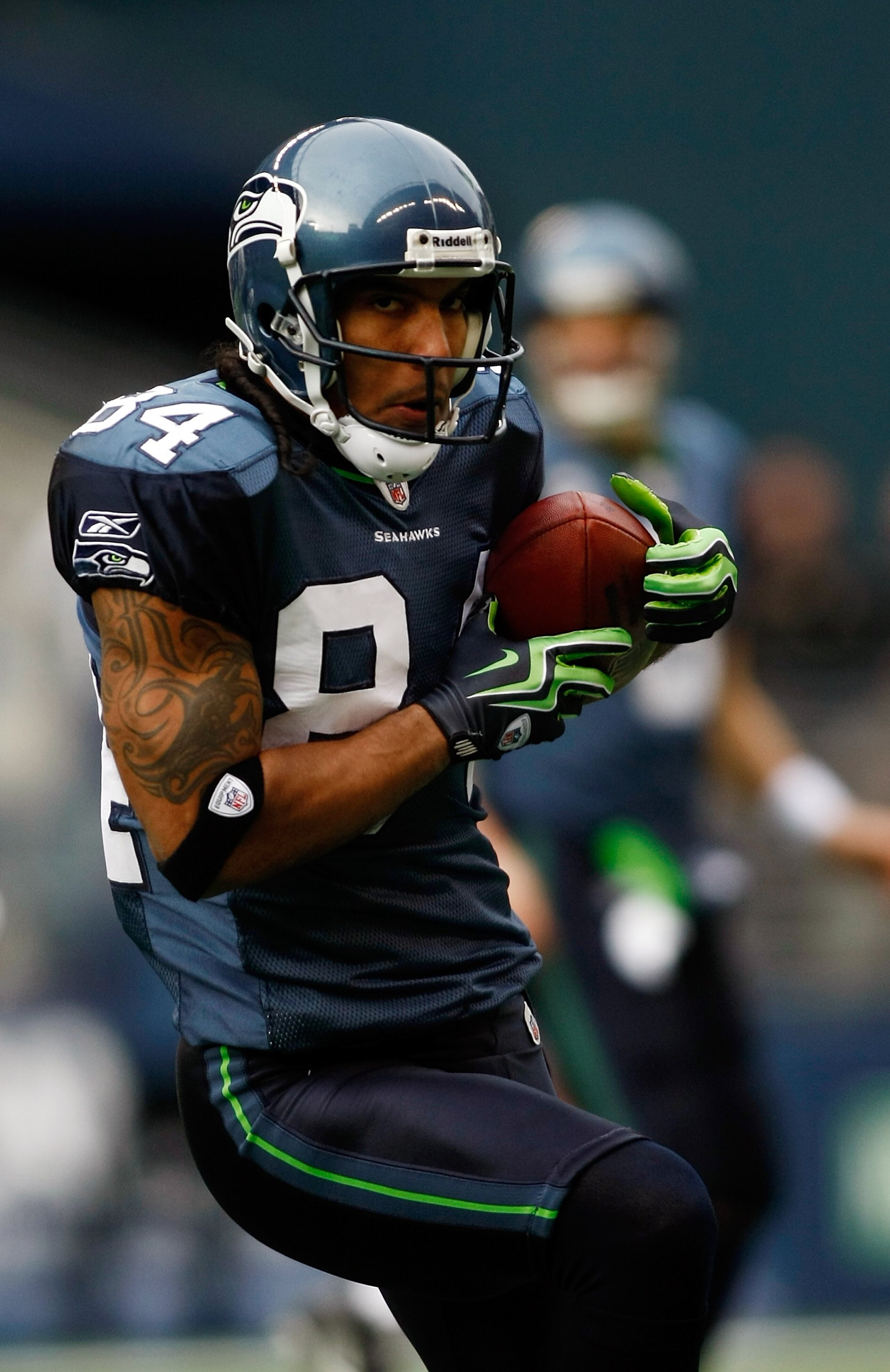 SEATTLE , WA - JANUARY 03:  T.J. Houshmandzadeh #84 of the Seattle Seahawks runs after a catch against the Tennessee Titans at Qwest Field on January 3, 2010 in Seattle, Washington.  (Photo by Jonathan Ferrey/Getty Images)