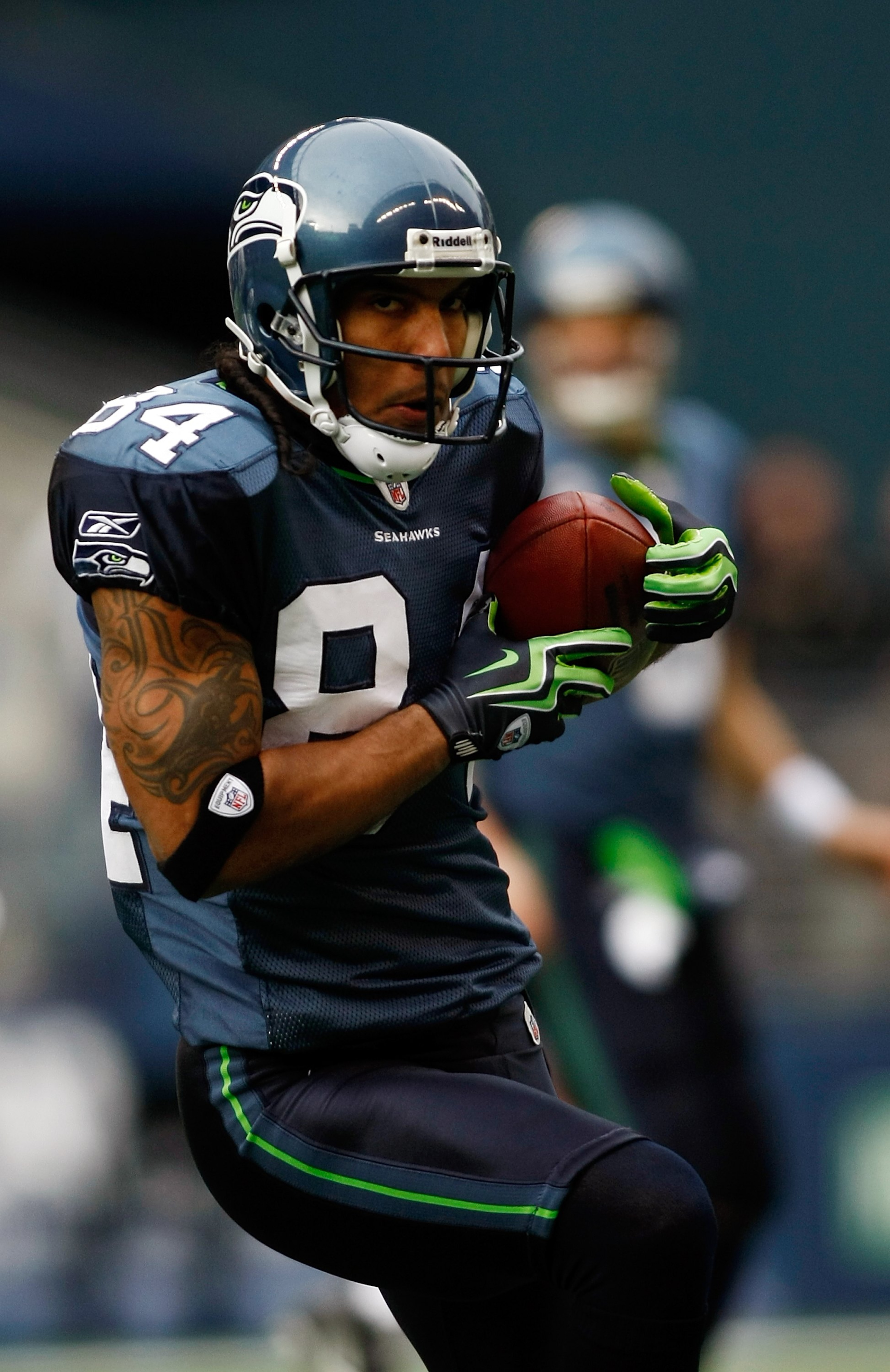 SEATTLE , WA - JANUARY 03:  T.J. Houshmandzadeh #84 of the Seattle Seahawks runs after a catch against the Tennessee Titans at Qwest Field on January 3, 2010 in Seattle, Washington.  (Photo by Jonathan Ferrey/Getty Images)