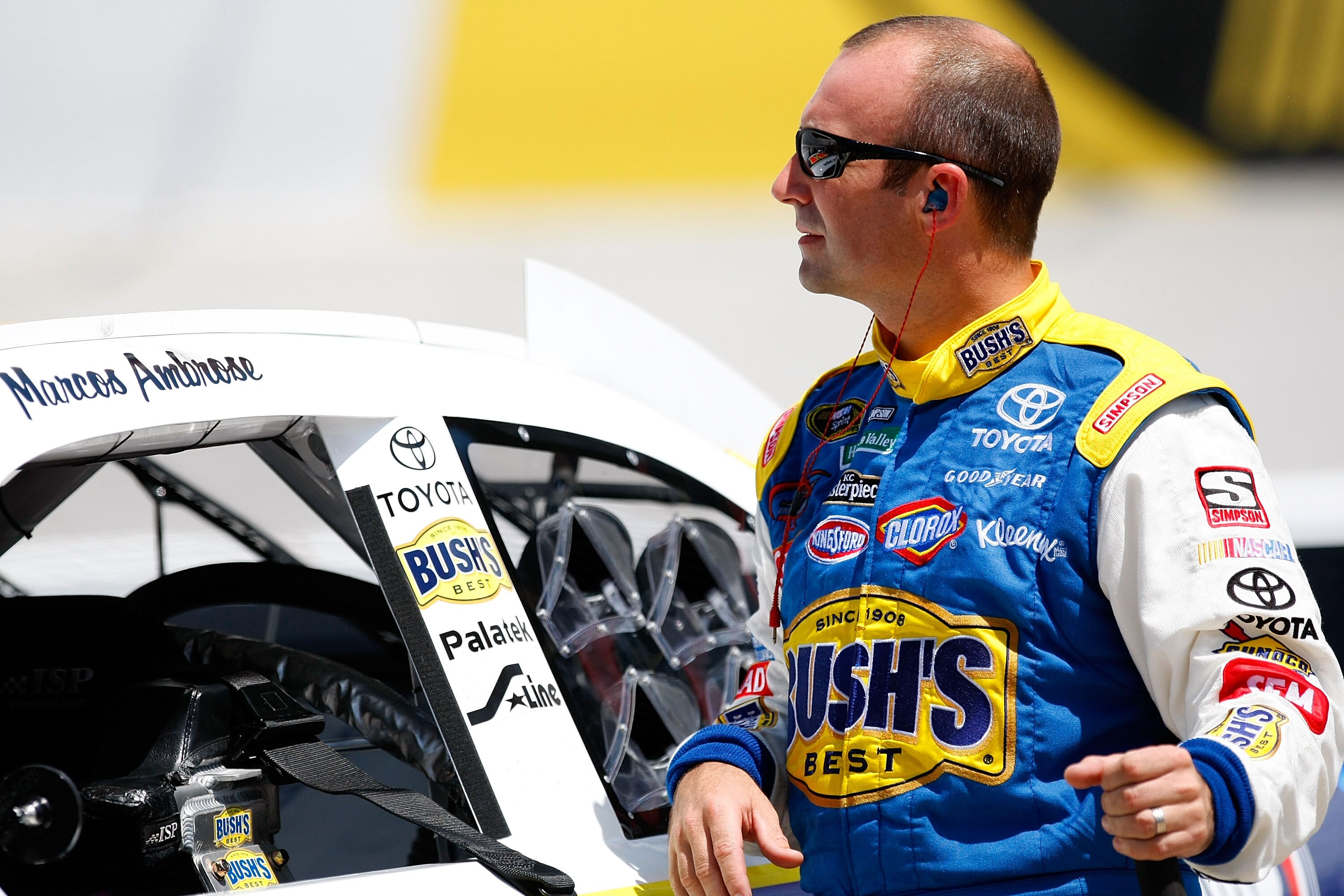 BRISTOL, TN - AUGUST 20: Marcos Ambrose, driver of the #47 Bush's/Kingsford Toyota, stands by his car in the garage area during practice for the NASCAR Sprint Cup Series IRWIN Tools Night Race at Bristol Motor Speedway on August 20, 2010 in Bristol, Tenne