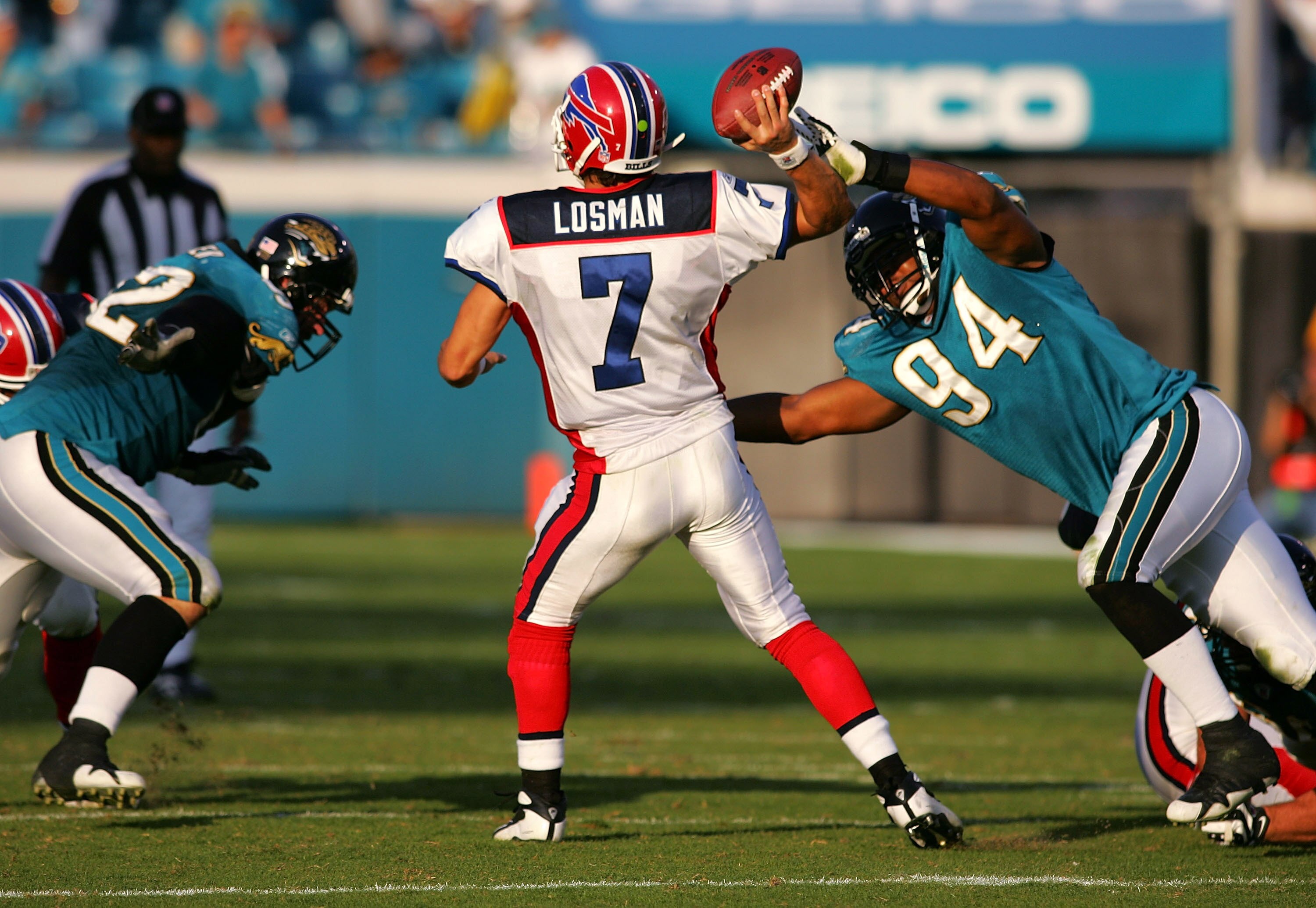 JACKSONVILLE, FL - NOVEMBER 25:  J.P. Losman #7 of the Buffalo Bills is pressured by Jeremy Mincey #94 of the Jacksonville Jaguars November 25, 2007 at Jacksonville Municipal Stadium in Jacksonville, Florida.  The Jaguars beat the Bills 36-14.  (Photo by 