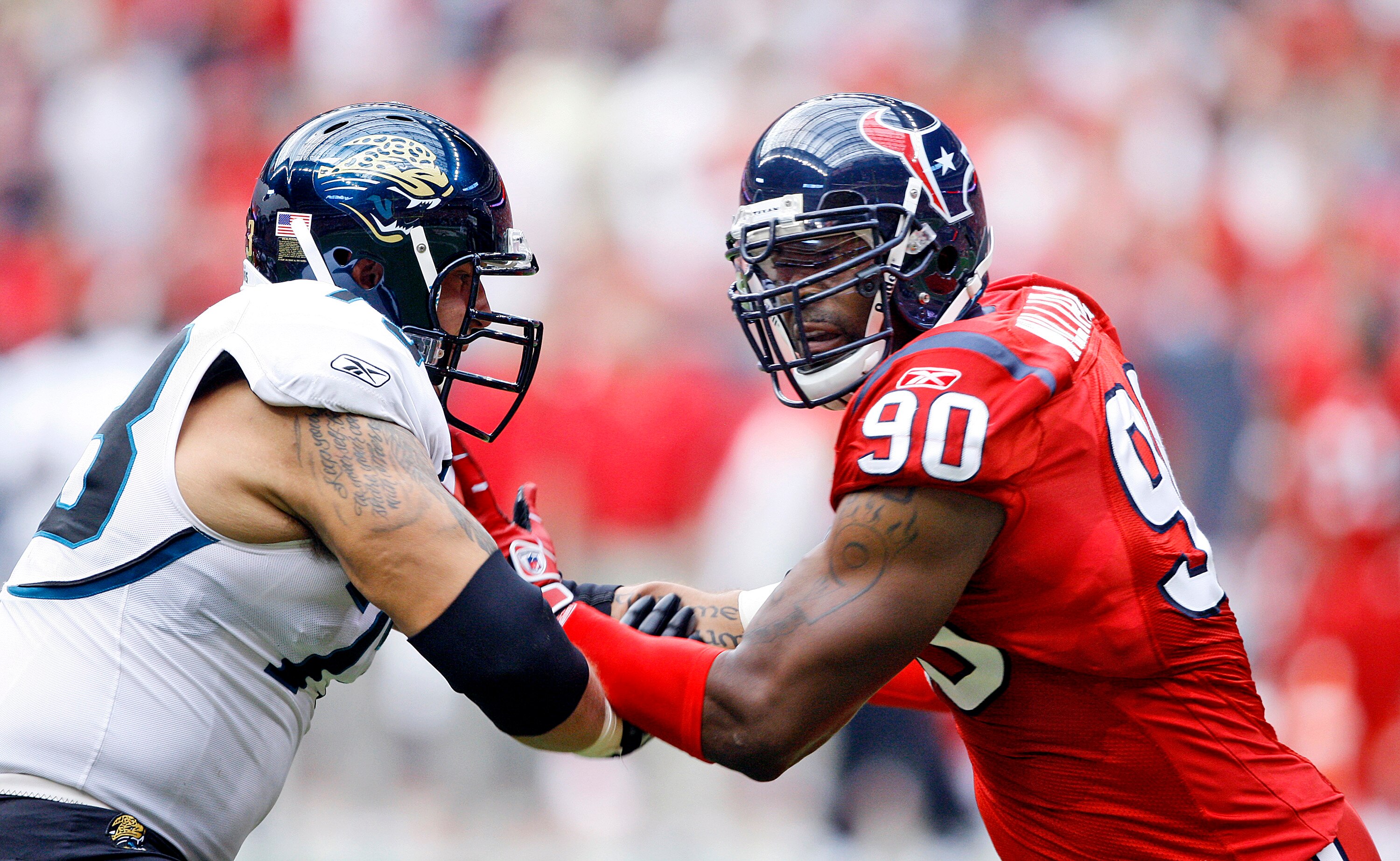 HOUSTON - SEPTEMBER 27:  Offensive tackle Jordan Black #78 of the Jacksonville Jaguars and defensive end Mario Williams #90 of the Houston Texans hook up at Reliant Stadium on September 27, 2009 in Houston, Texas.  (Photo by Bob Levey/Getty Images)