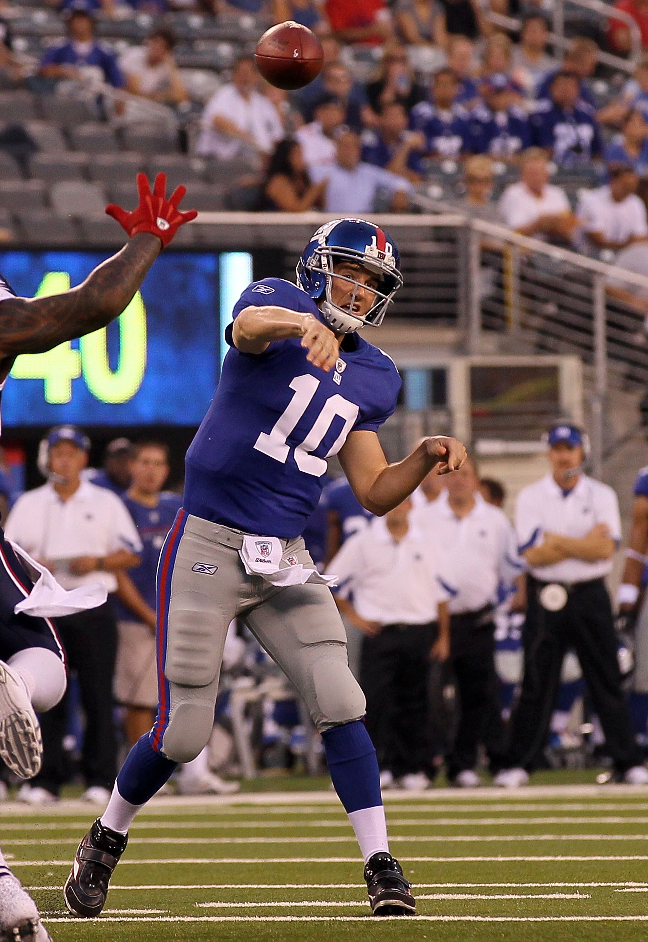 EAST RUTHERFORD, NJ - SEPTEMBER 02:  Eli Manning #10 of the New York Giants throws a first quarter touchdown pass against the New England Patriots to teammate Kevin Boss (not pictured) on September 2, 2010 at the New Meadowlands Stadium in East Rutherford
