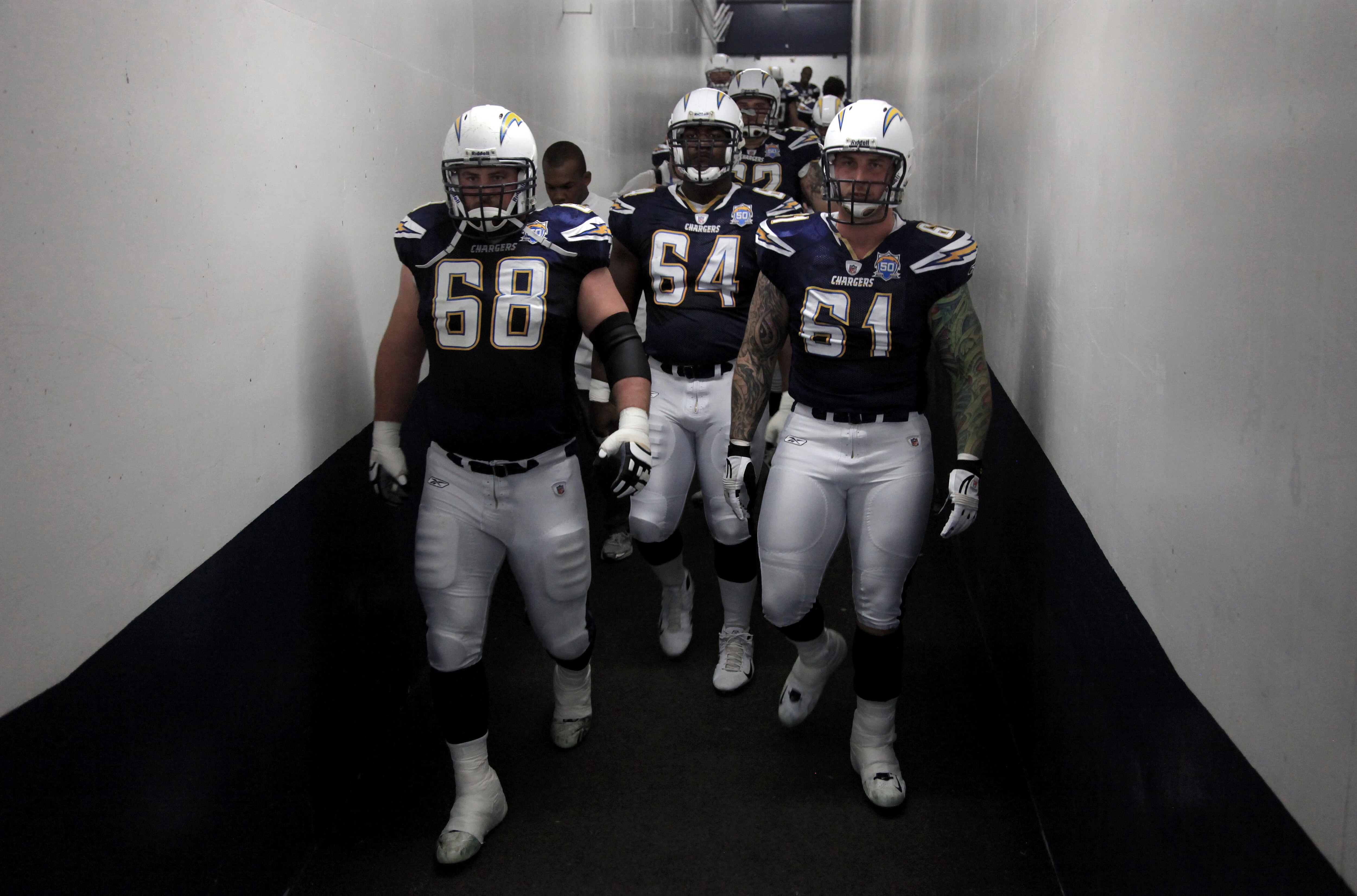 SAN DIEGO, CA - JANUARY 3:  Kris Dielman #68, Dennis Norman #64, and Nick Hardwick #61 of the San Diego Chargers enter the field against the Washington Redskins during the Washington Redskins  v San Diego Chargers NFL Game on January 3, 2010 at Quolcomm S