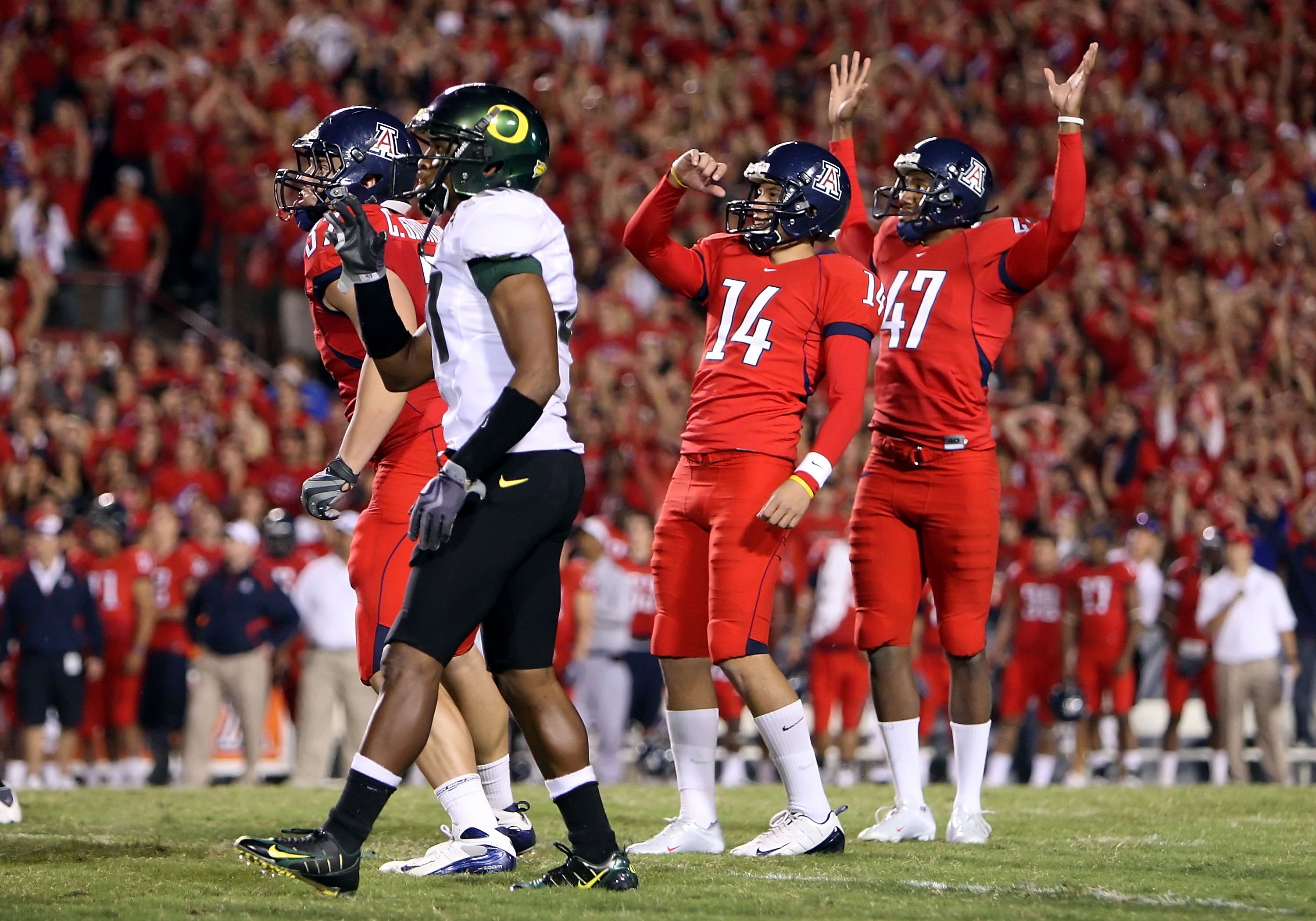 TUCSON, AZ - NOVEMBER 21:  Kicker Alex Zendejas #14 and Keenyn Crier #47 of the Arizona Wildcats celebrate kicking a field goal against the Oregon Ducks during the college football game at Arizona Stadium on November 21, 2009 in Tucson, Arizona.The Ducks