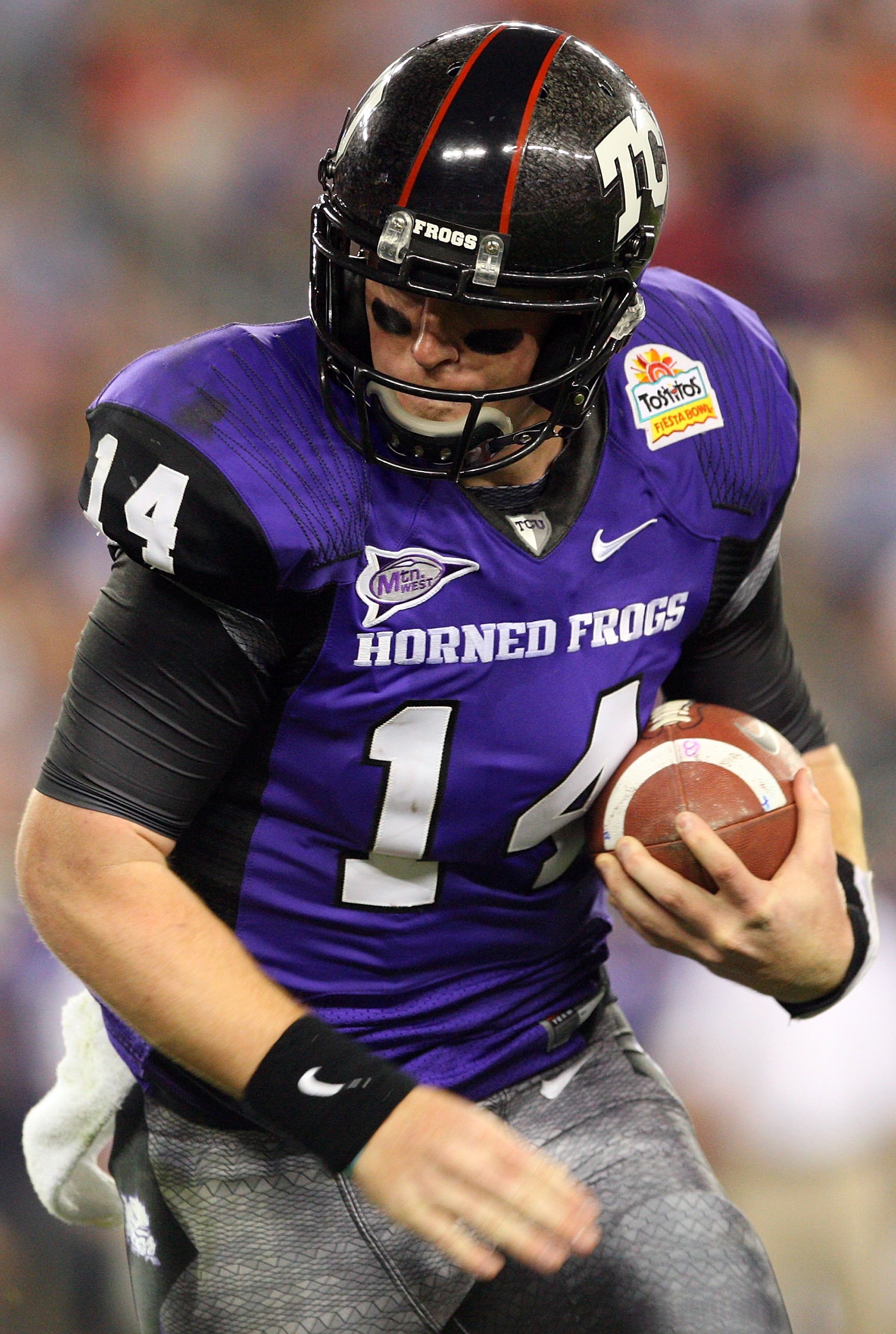 GLENDALE, AZ - JANUARY 04:  Quarterback Andy Dalton #14 of the TCU Horned Frogs runs the ball against the Boise State Broncos during the Tostitos Fiesta Bowl at the Universtity of Phoenix Stadium on January 4, 2010 in Glendale, Arizona.  (Photo by Christi