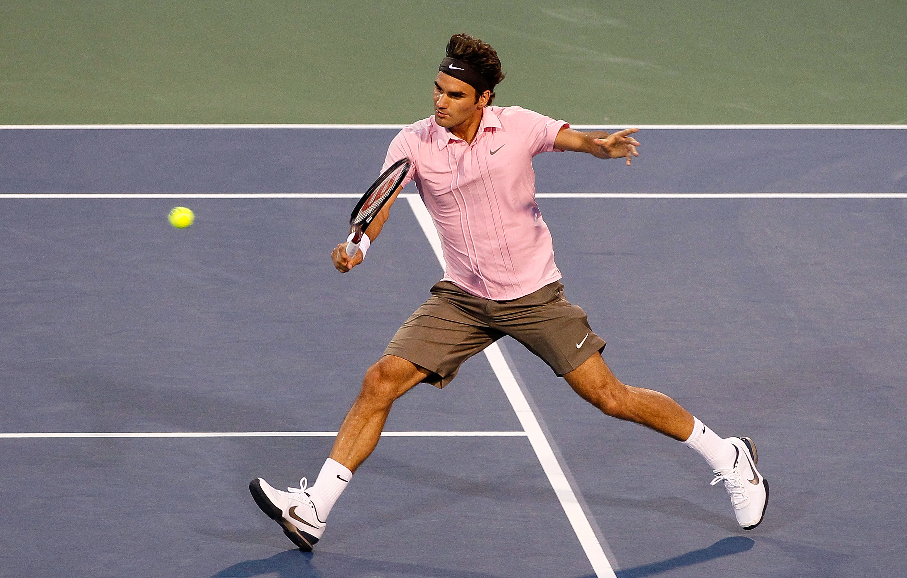 CINCINNATI - AUGUST 21:  Roger Federer of Switzerland returns a backhand to Marcos Baghdatis of Cyprus during the semifinals on Day 6 of the Western & Southern Financial Group Masters at the Lindner Family Tennis Center on August 21, 2010 in Cincinnati, O