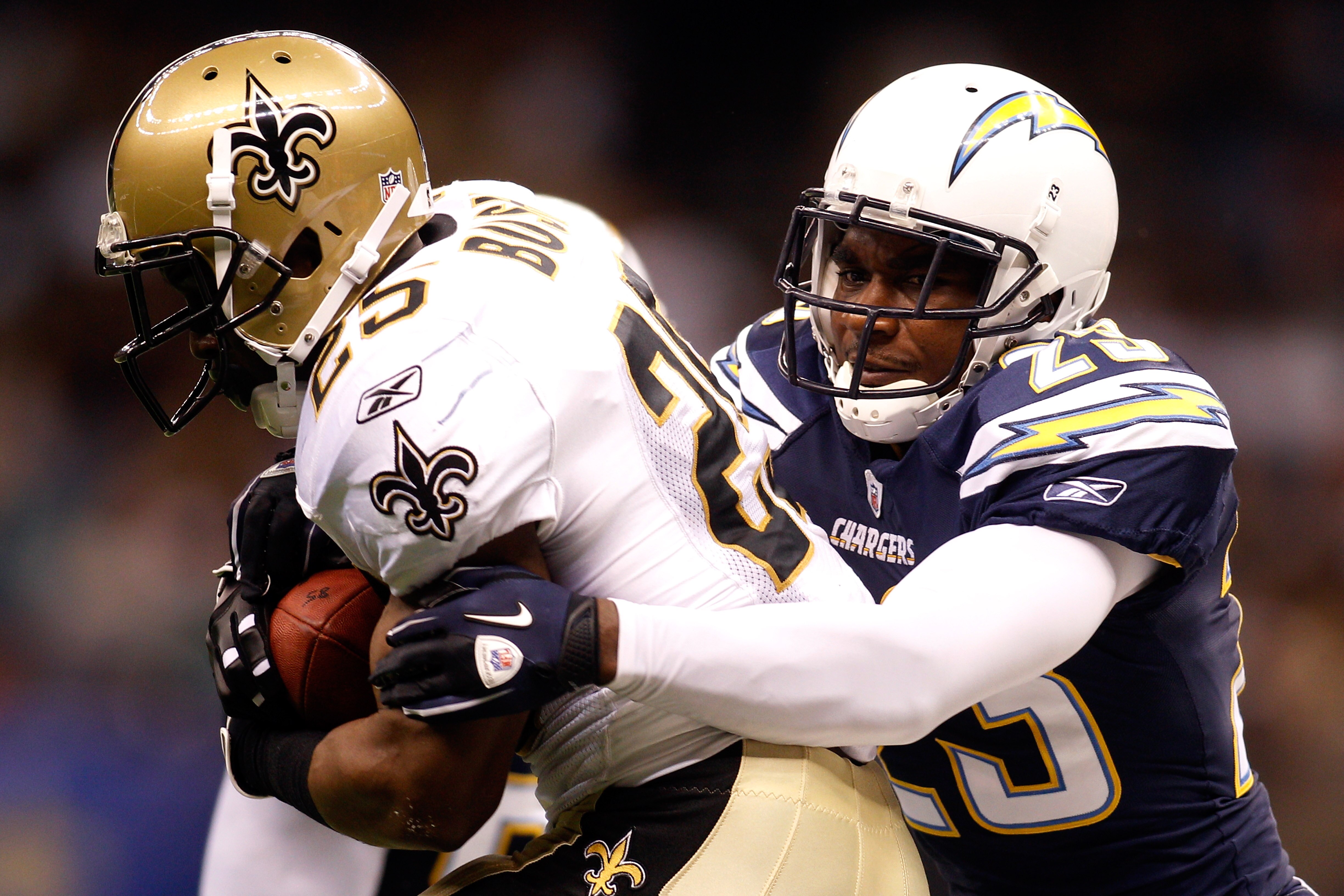 NEW ORLEANS - AUGUST 27:  Reggie Bush #25 of the New Orleans Saints is tackled by Quentin Jammer #23 of the San Diego Chargers at the Louisiana Superdome on August 27, 2010 in New Orleans, Louisiana.  (Photo by Chris Graythen/Getty Images)