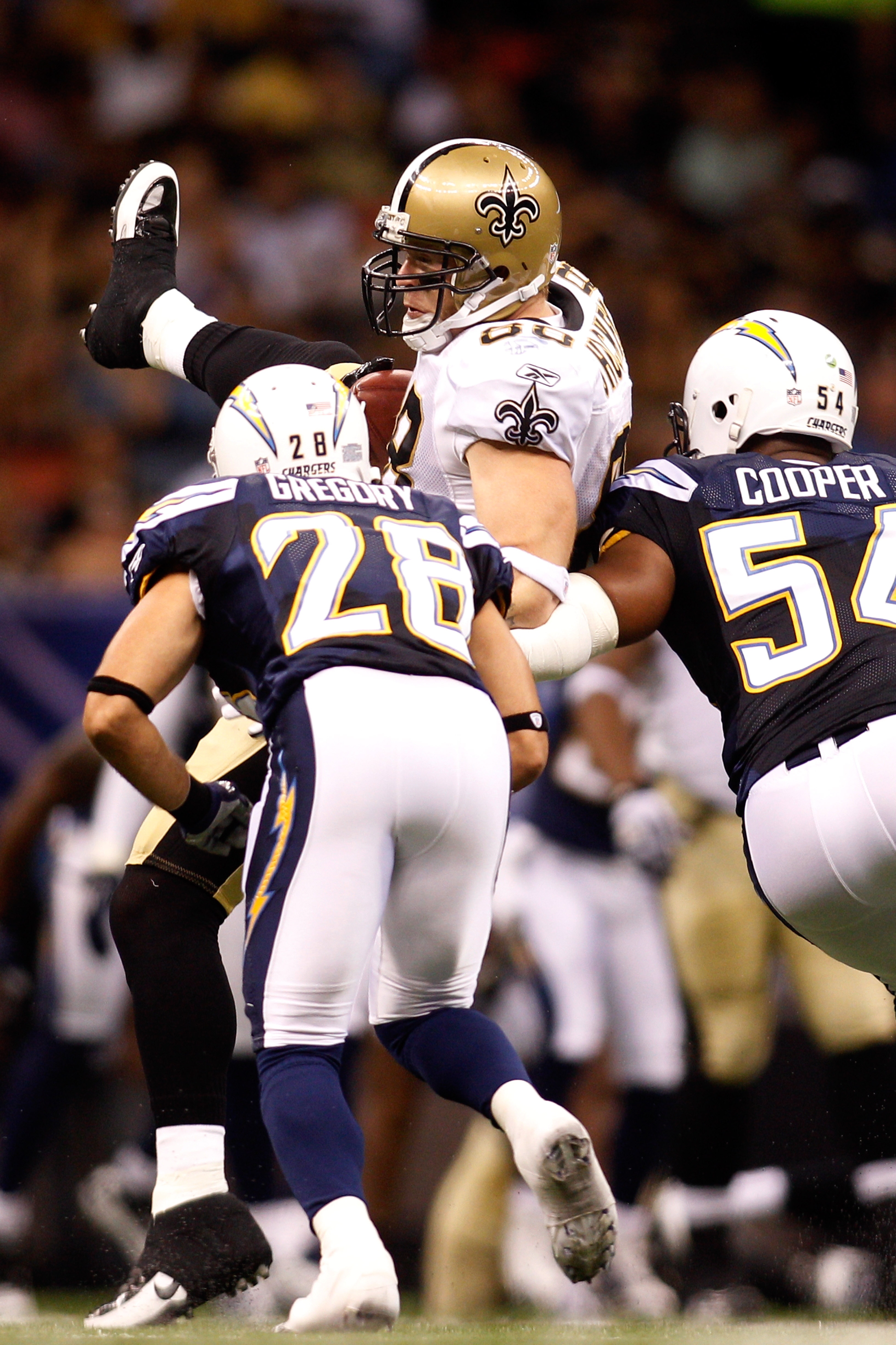 NEW ORLEANS - AUGUST 27:  Jeremy Shockey #88 of the New Orleans Saints is tackled by Steve Gregory #28 and Stephen Cooper #54 of the San Diego Chargers at the Louisiana Superdome on August 27, 2010 in New Orleans, Louisiana.  (Photo by Chris Graythen/Gett