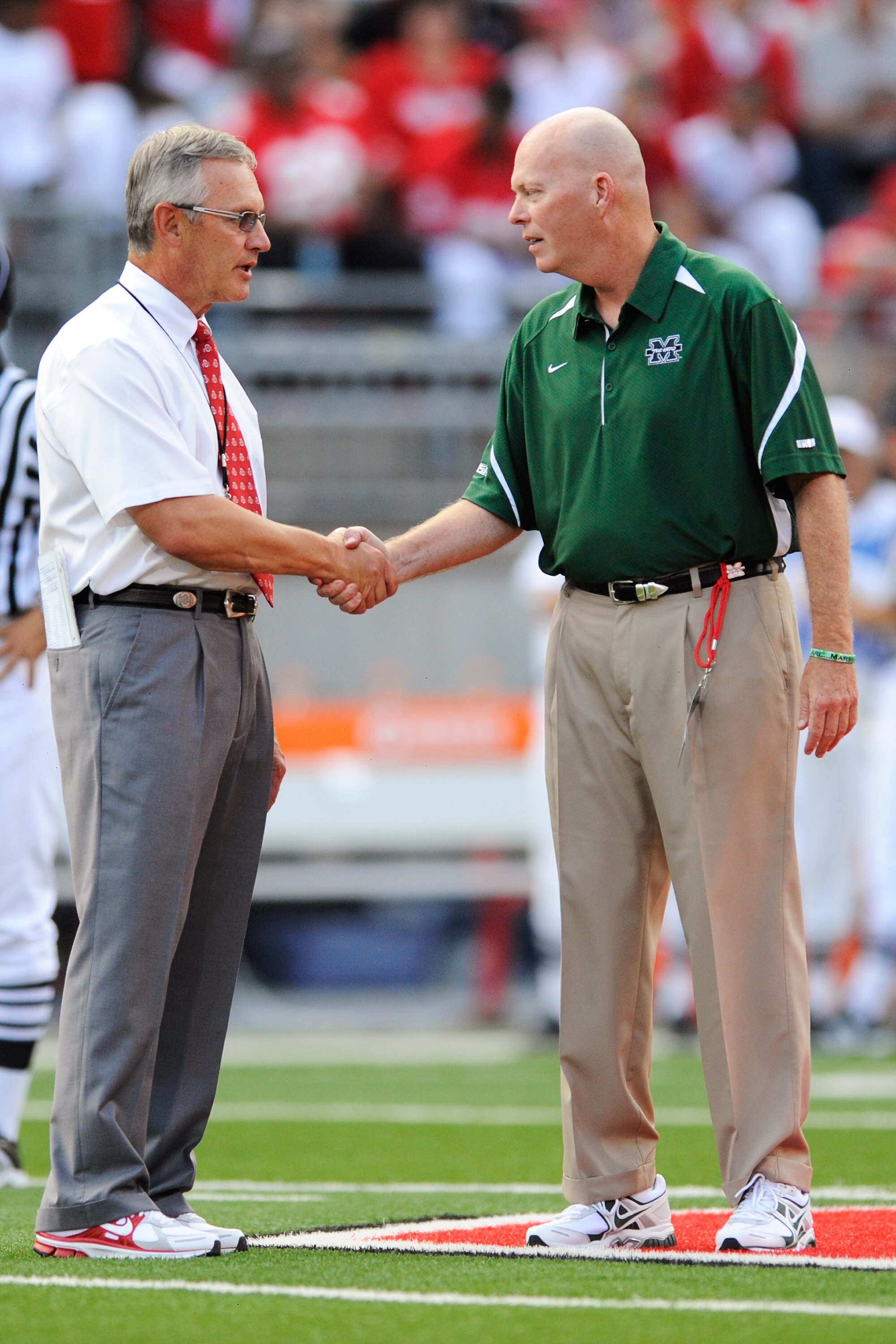 COLUMBUS, OH - SEPTEMBER 2: Head coach Jim Tressel (L) of the Ohio State Buckeyes shakes hands with assistant coach Bill Legg of the Marshall Thundering Herd before their game at Ohio Stadium on September 2, 2010 in Columbus, Ohio. (Photo by Jamie Sabau COLUMBUS, OH - SEPTEMBER 2: Head coach Jim Tressel (L) of the Ohio State Buckeyes shakes hands with assistant coach Bill Legg of the Marshall Thundering Herd before their game at Ohio Stadium on September 2, 2010 in Columbus, Ohio. (Photo by Jamie Sabau