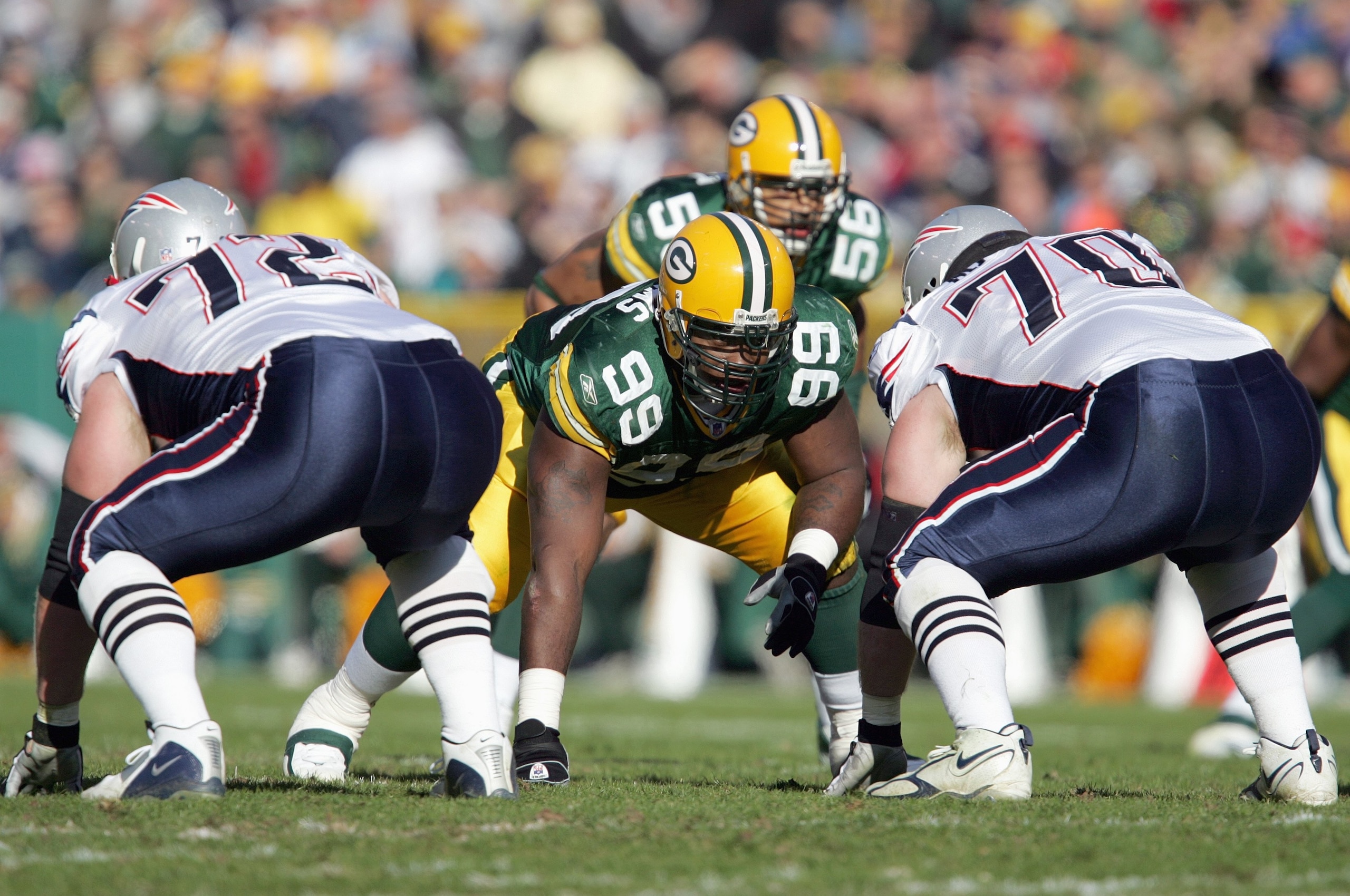GREEN BAY, WI - NOVEMBER 19:  Corey Williams #99 of the Green Bay Packers gets ready on the line of scrimmage against Matt Light #72 and Logan Mankins #70 of the New England Patriots on November 19, 2006 at Lambeau Field in Green Bay, Wisconsin. The Patri