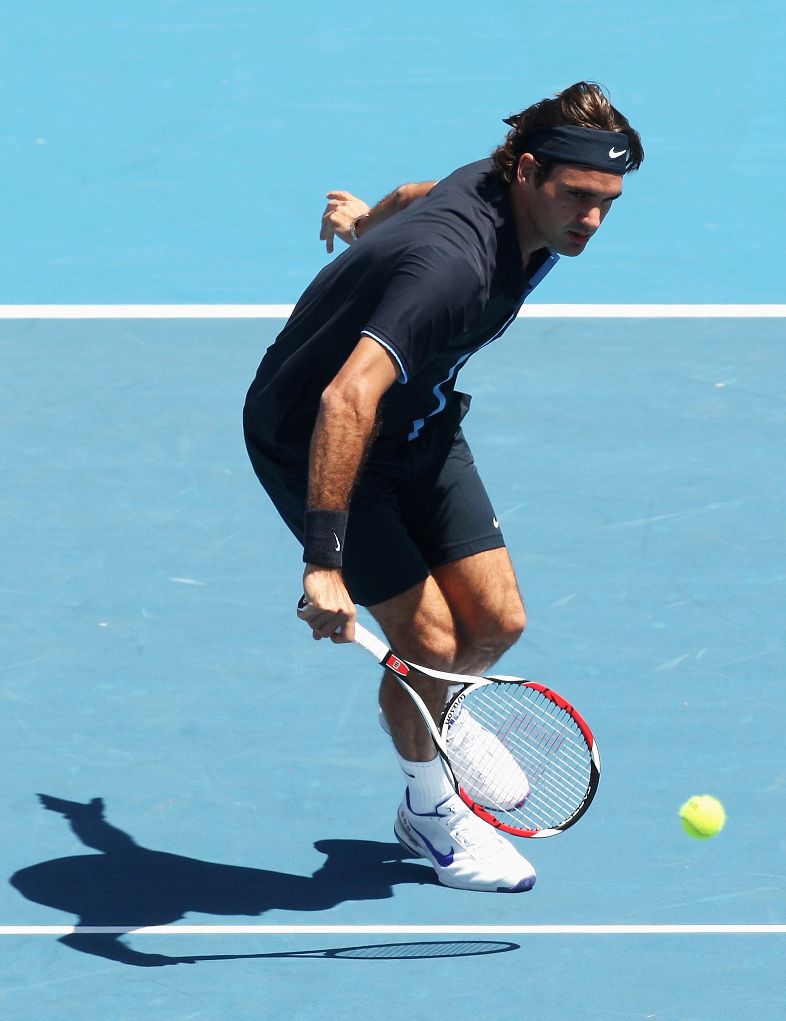 MELBOURNE, AUSTRALIA - JANUARY 17:  Roger Federer of Switzerland plays a backhand volley during the final against Stanislas Wawrinka of Switzerland on day four of the AAMI Classic at the Kooyong Lawn Tennis Club on January 17, 2009 in Melbourne, Australia