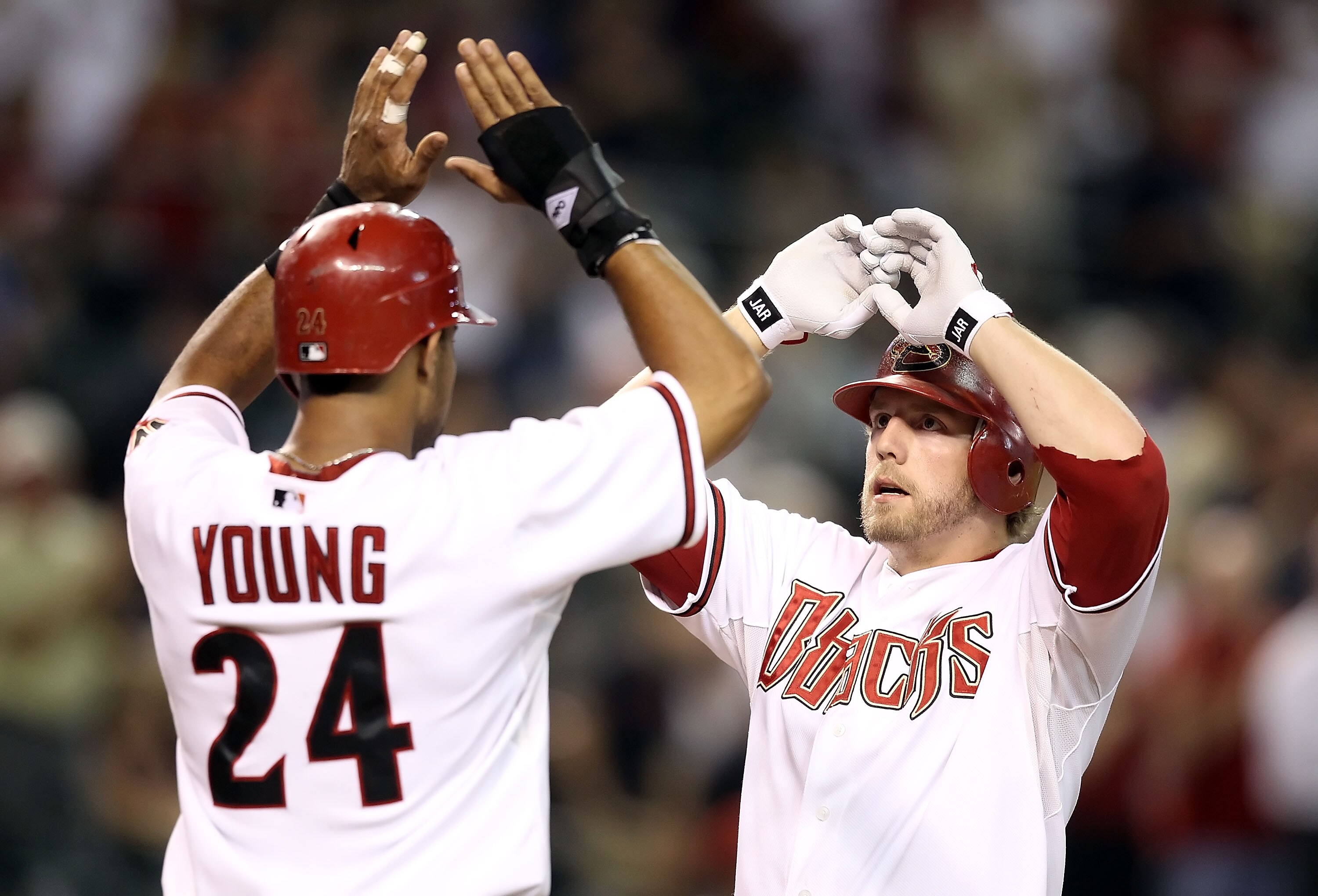 PHOENIX - AUGUST 30:  Mark Reynolds #27 of the Arizona Diamondbacks is congratulated by teammate Chris Young #24 after Reynolds hit a 2 run home run against the San Diego Padres during the third inning of the Major League Baseball game at Chase Field on A