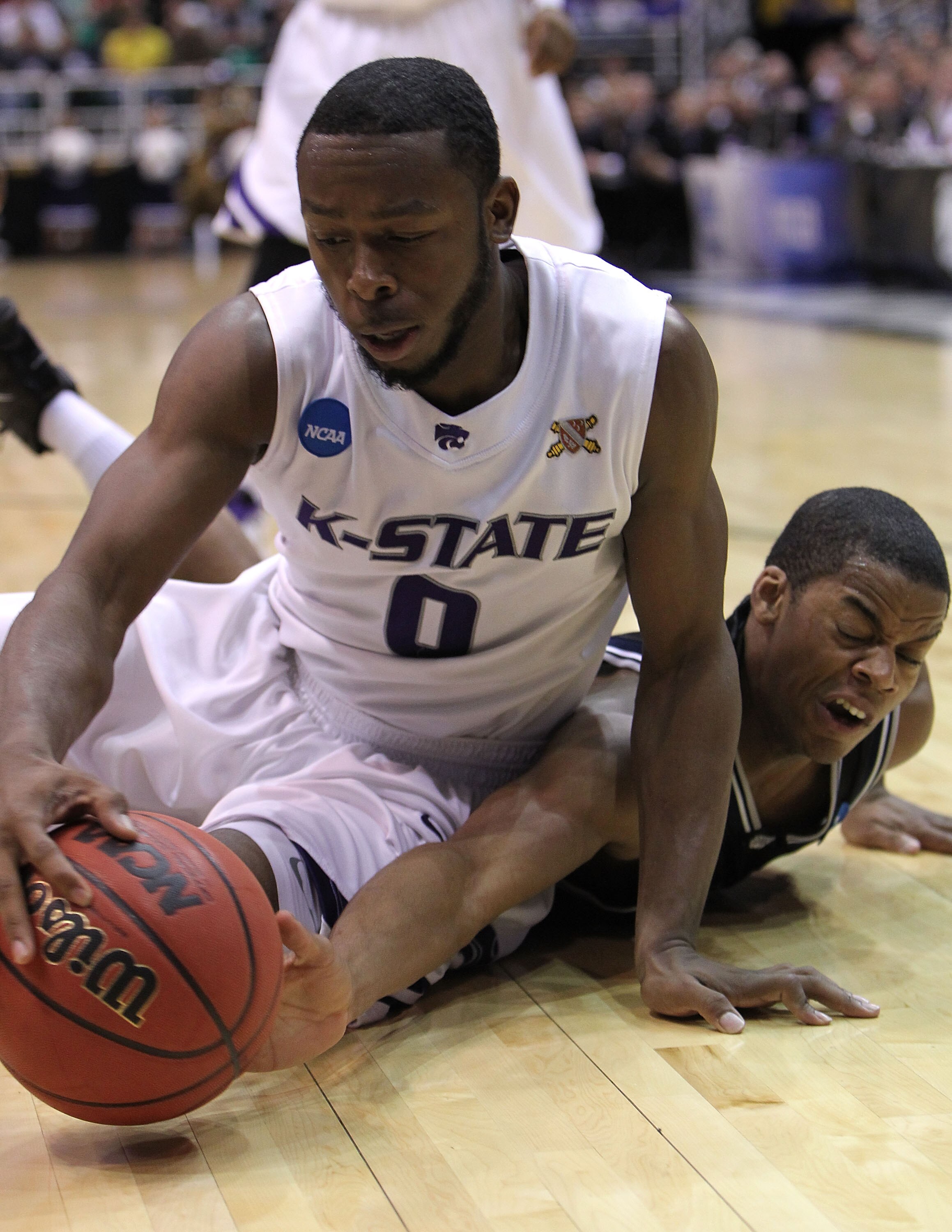 SALT LAKE CITY - MARCH 27:  Ronald Nored #5 of the Butler Bulldogs battles for the ball with Jacob Pullen #0 of the Kansas State Wildcats during the west regional final of the 2010 NCAA men's basketball tournament at the Energy Solutions Arena on March 27