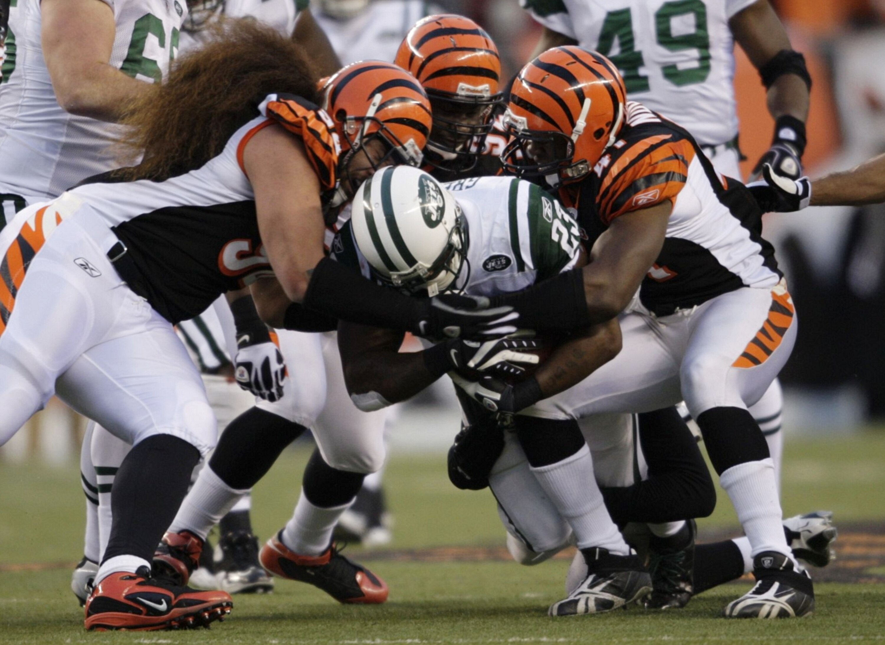 CINCINNATI - JANUARY 9: Running back Shonn Greene #23 of the New York Jets is tackled as he runs with the ball against the Cincinnati Bengals during the 2010 AFC wild-card playoff game at Paul Brown Stadium on January 9, 2010 in Cincinnati, Ohio. (Photo b