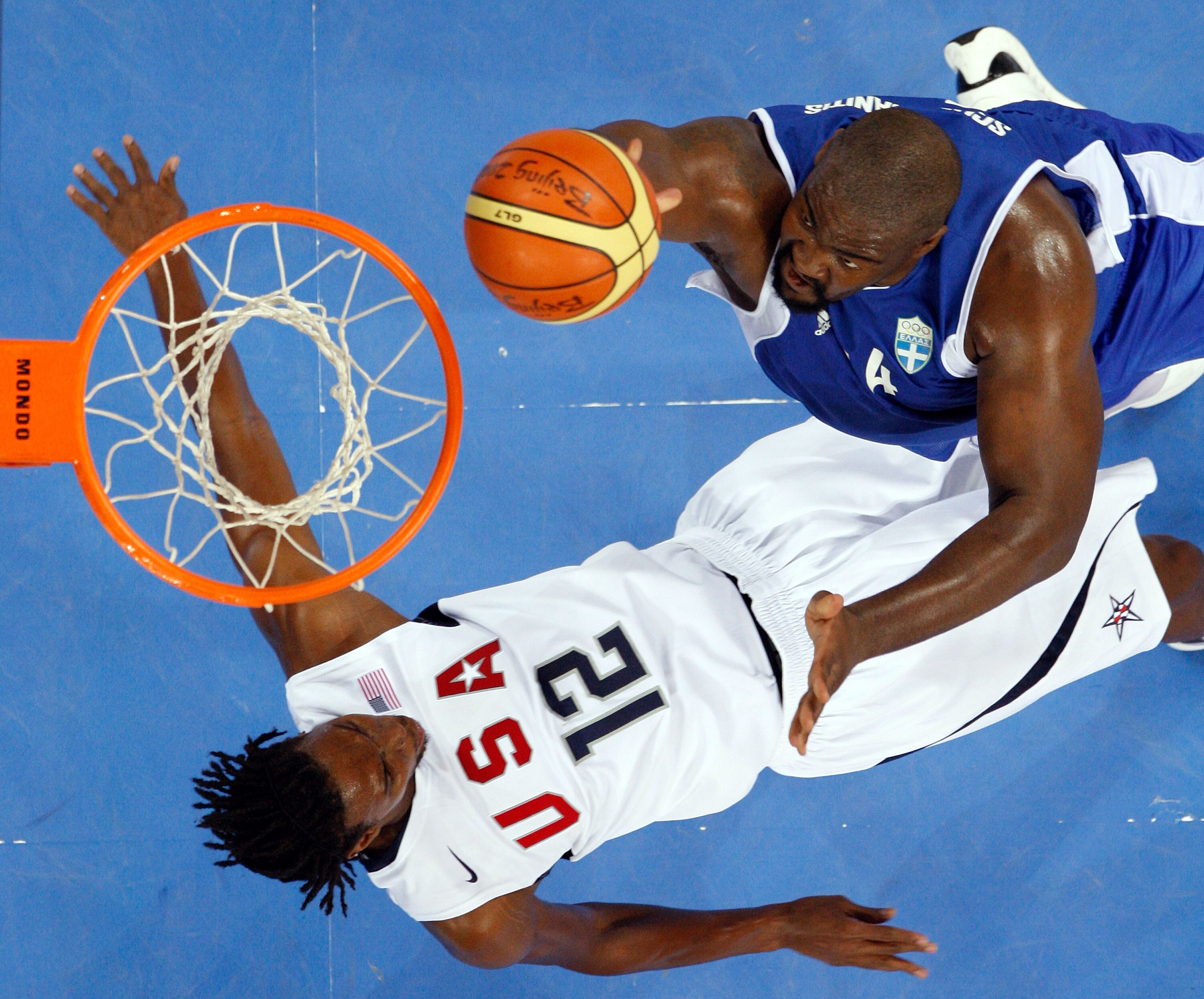 BEIJING - AUGUST 14:  Sofoklis Schortsanitis #14 of Greece dgoes up for a shot as he knocks back Chris Bosh #12 of the United States during the Men's Preliminary Round Group A basketball game at the Olympic Basketball Gymnasium during day 6 of the Beijing