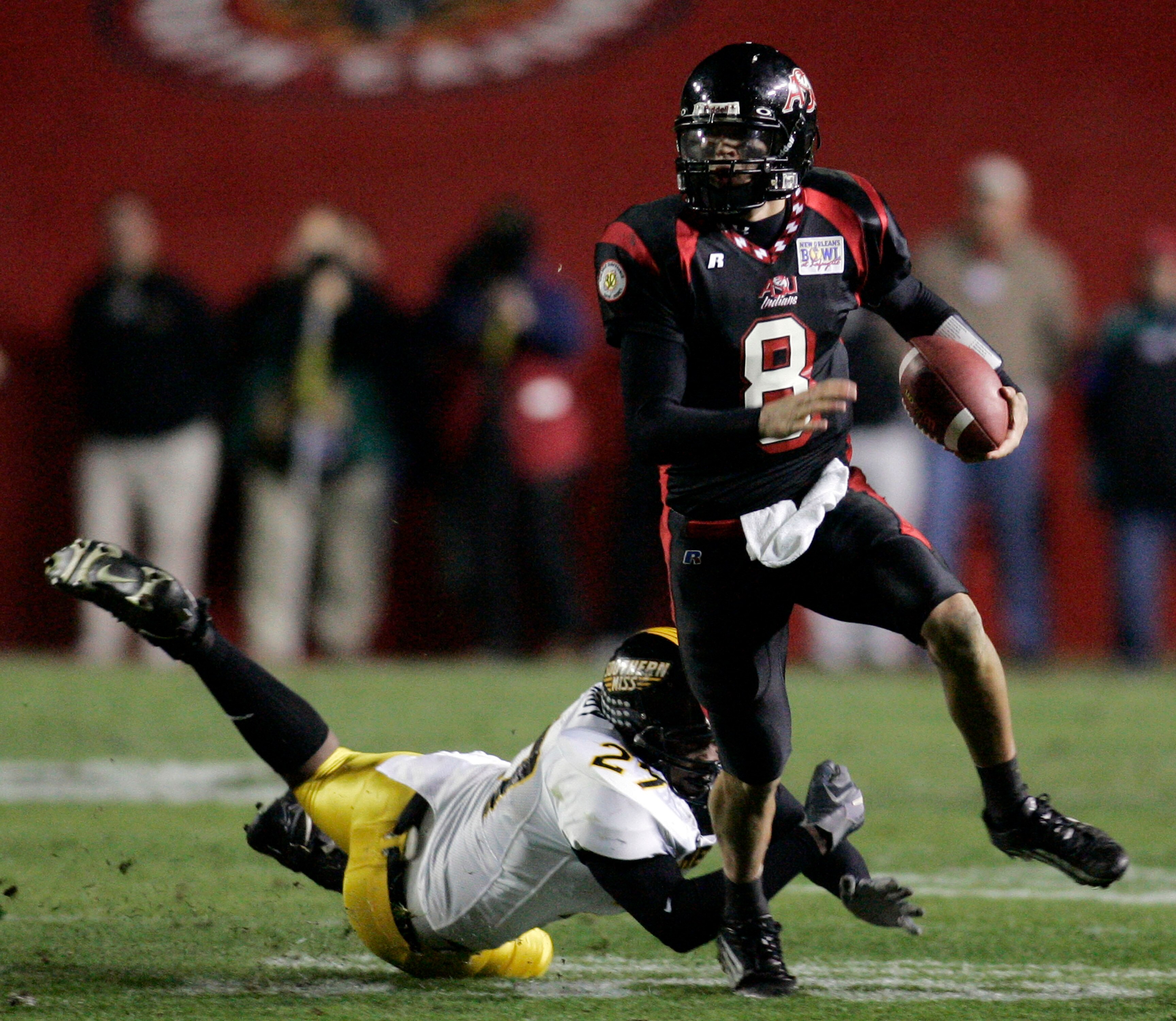LAFAYETTE, LA - DECEMBER 20: Quarterback Nick Noce #8 of Arkansas State avoids a tackle by Wayne Hardy #27 of Southern Miss during The New Orleans Bowl on December 20, 2005 at Cajun Field in Lafayette, Louisiana. Southern Miss defeated Arkansas State 31 LAFAYETTE, LA - DECEMBER 20: Quarterback Nick Noce #8 of Arkansas State avoids a tackle by Wayne Hardy #27 of Southern Miss during The New Orleans Bowl on December 20, 2005 at Cajun Field in Lafayette, Louisiana. Southern Miss defeated Arkansas State 31