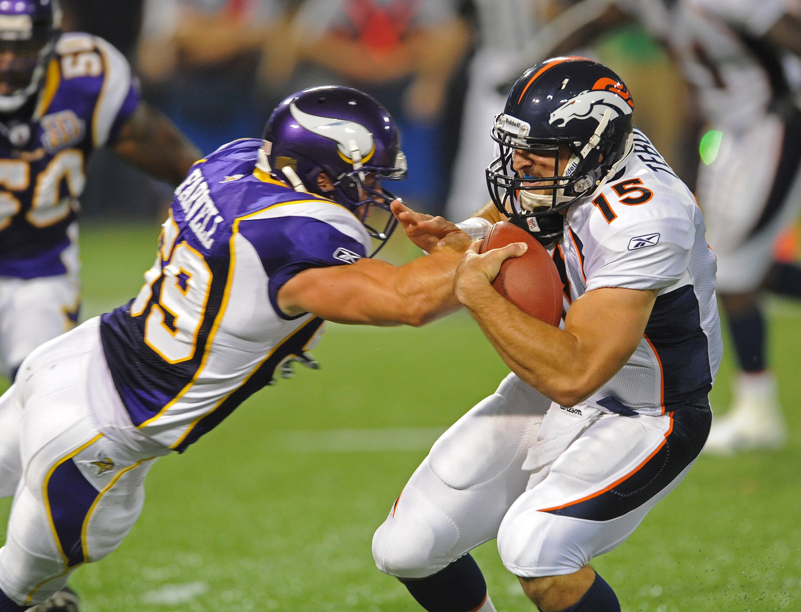 MINNEAPOLIS - SEPTEMBER 02:  Tim Tebow #15 of the Denver Broncos carries the ball and is tackled by Heath Farwell #59 of the Minnesota Vikings  during an NFL preseason game at the Mall of America Field at Hubert H. Humphrey Metrodome, on September 2, 2010