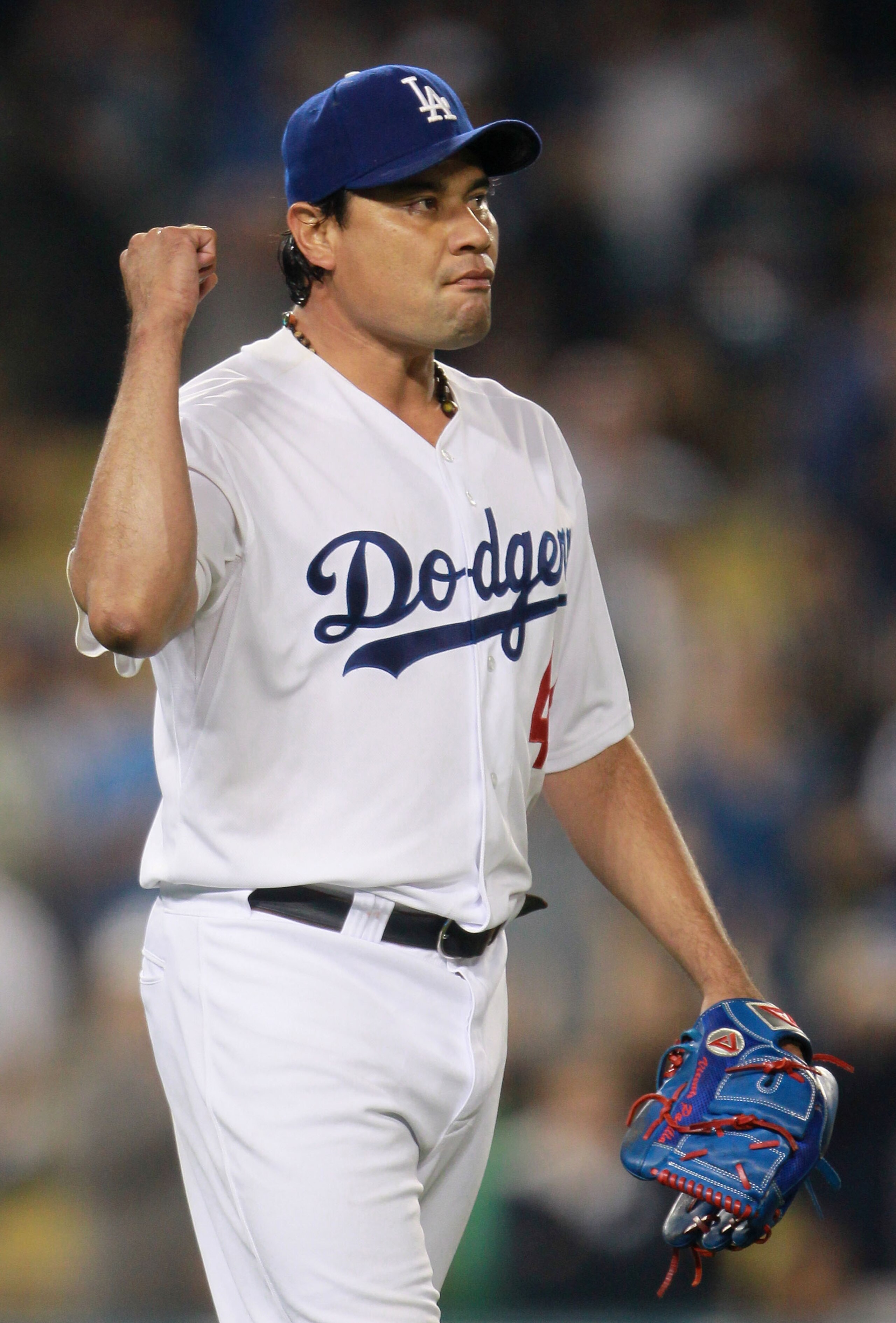 LOS ANGELES, CA - AUGUST 04:  Starting pitcher Vicente Padilla #44 of the Los Angeles Dodgers celebrates after the final out in the ninth inning against the San Diego Padres at Dodger Stadium on August 4, 2010 in Los Angeles, California. The Dodgers defea