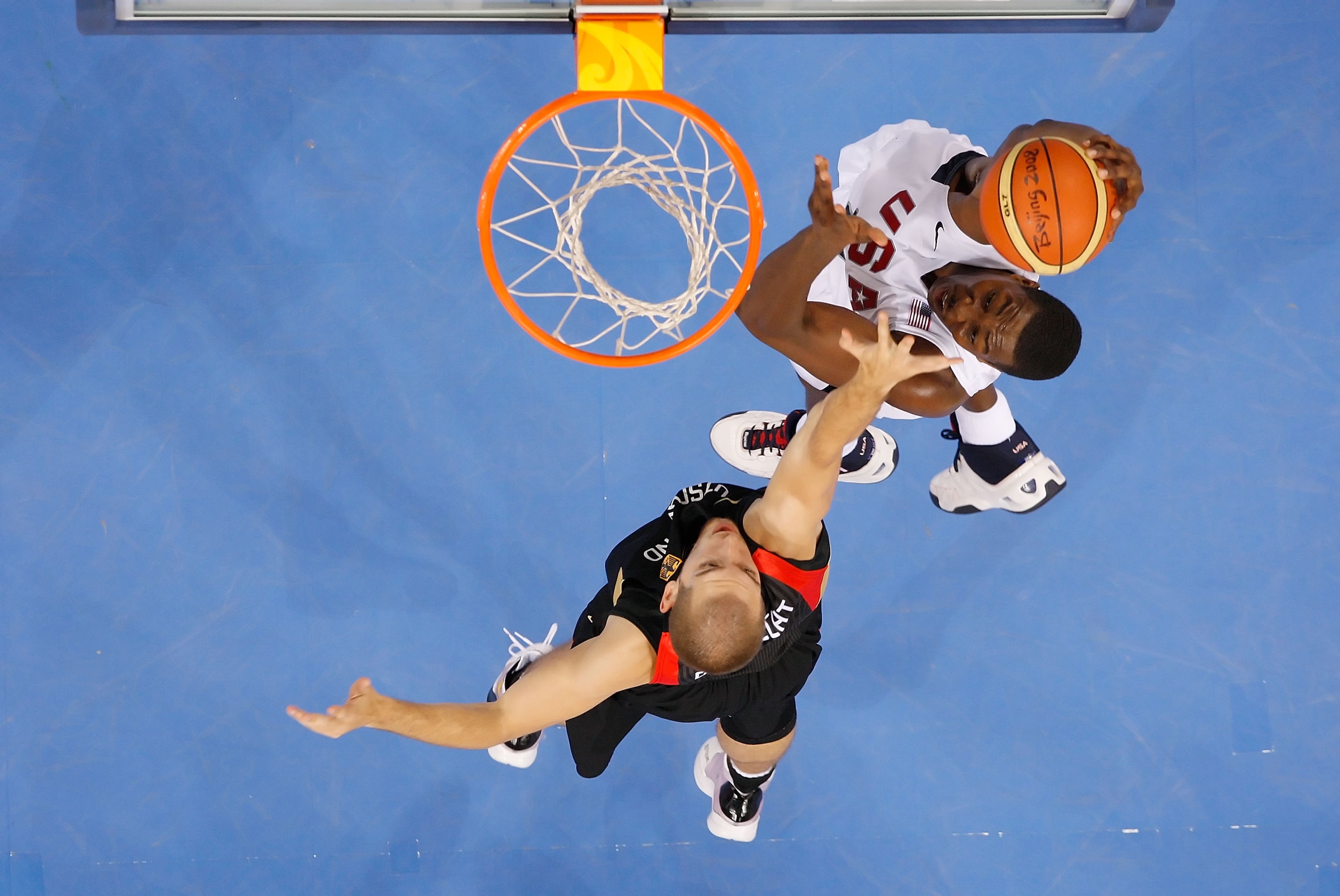 BEIJING - AUGUST 18:  Dwight Howard #11 of the United States dunks over the defense of Tim Ohlbrecht #4 of Germany during the men?s basketball preliminaries at the Wukesong Indoor Stadium on Day 10 of the Beijing 2008 Olympic Games on August 18, 2008 in B