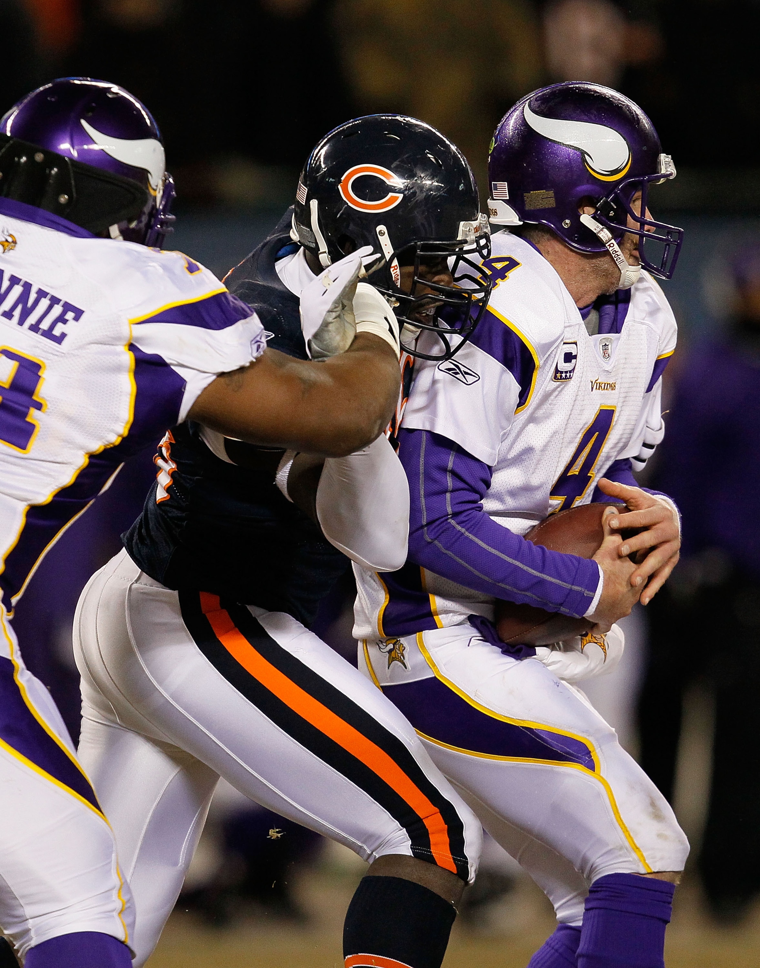 CHICAGO - DECEMBER 28: Brett Favre #4 of the Minnesota Vikings is sacked by Alex Brown #96 of the Chicago Bears as Bryant McKinnie #74 tries to stop him at Soldier Field on December 28, 2009 in Chicago, Illinois. The Bears defeated the Vikings 36-30 in ov