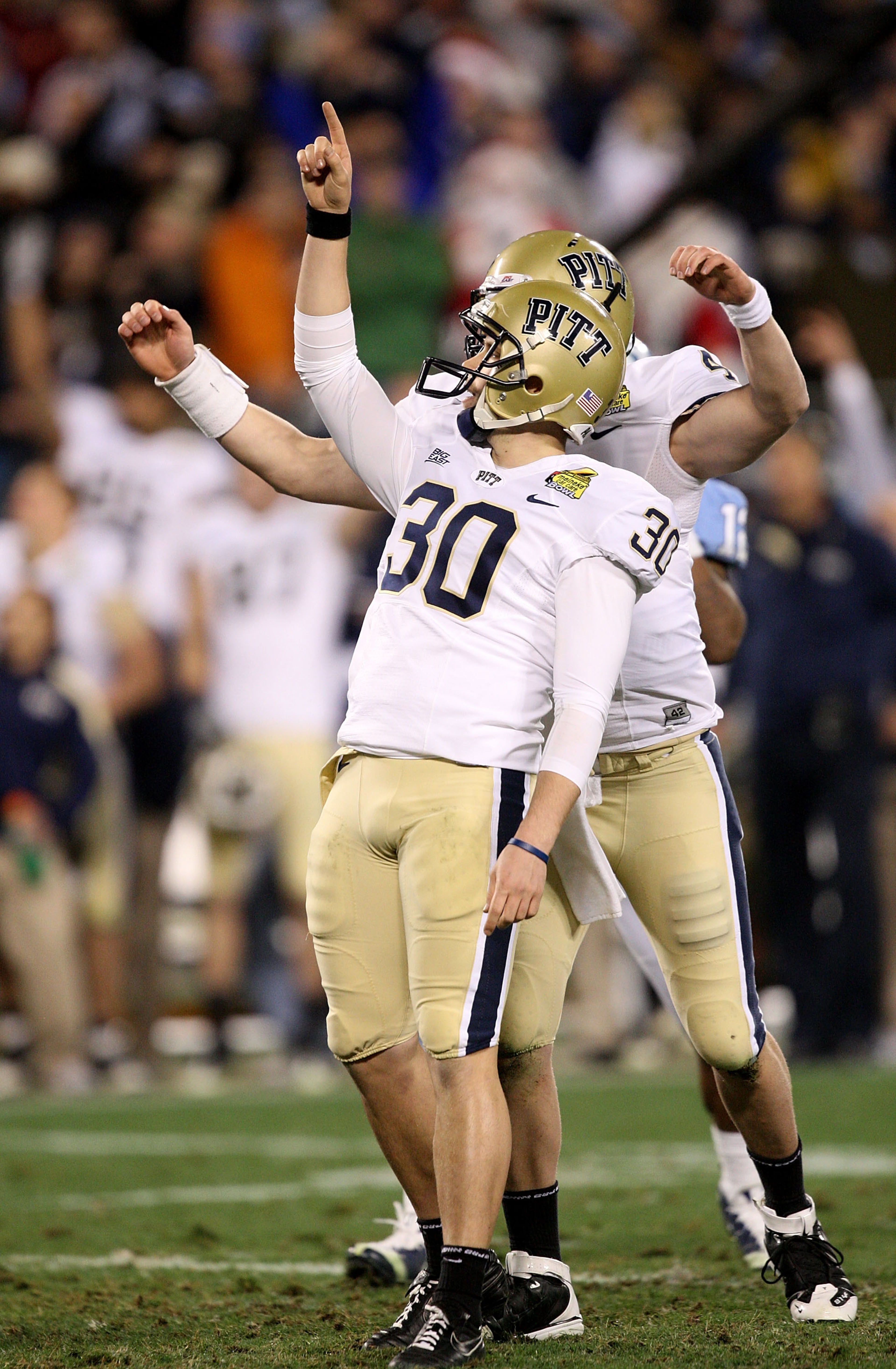 CHARLOTTE, NC - DECEMBER 26: Dan Hutchins #30 of the Pittsburgh Panthers celebrates with teammate Andrew Janocko #4 after making a game-winning field goal to defeat the North Carolina Tar Heels 19-17 during their game on December 26, 2009 in Charlotte, N CHARLOTTE, NC - DECEMBER 26: Dan Hutchins #30 of the Pittsburgh Panthers celebrates with teammate Andrew Janocko #4 after making a game-winning field goal to defeat the North Carolina Tar Heels 19-17 during their game on December 26, 2009 in Charlotte, N