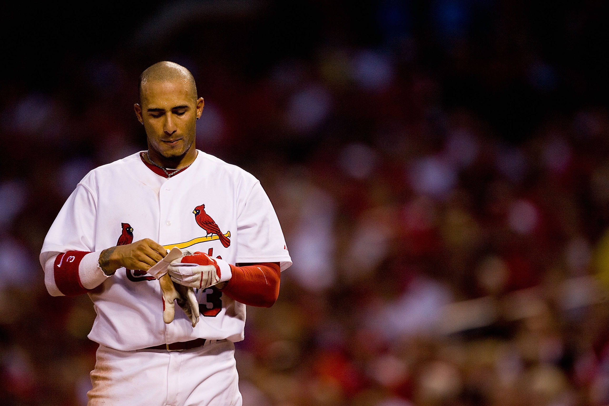 ST. LOUIS - JULY 20: Felipe Lopez #3 of the St. Louis Cardinals removes his batting gloves after striking out against the Philadelphia Phillies at Busch Stadium on July 20, 2010 in St. Louis, Missouri.  (Photo by Dilip Vishwanat/Getty Images)