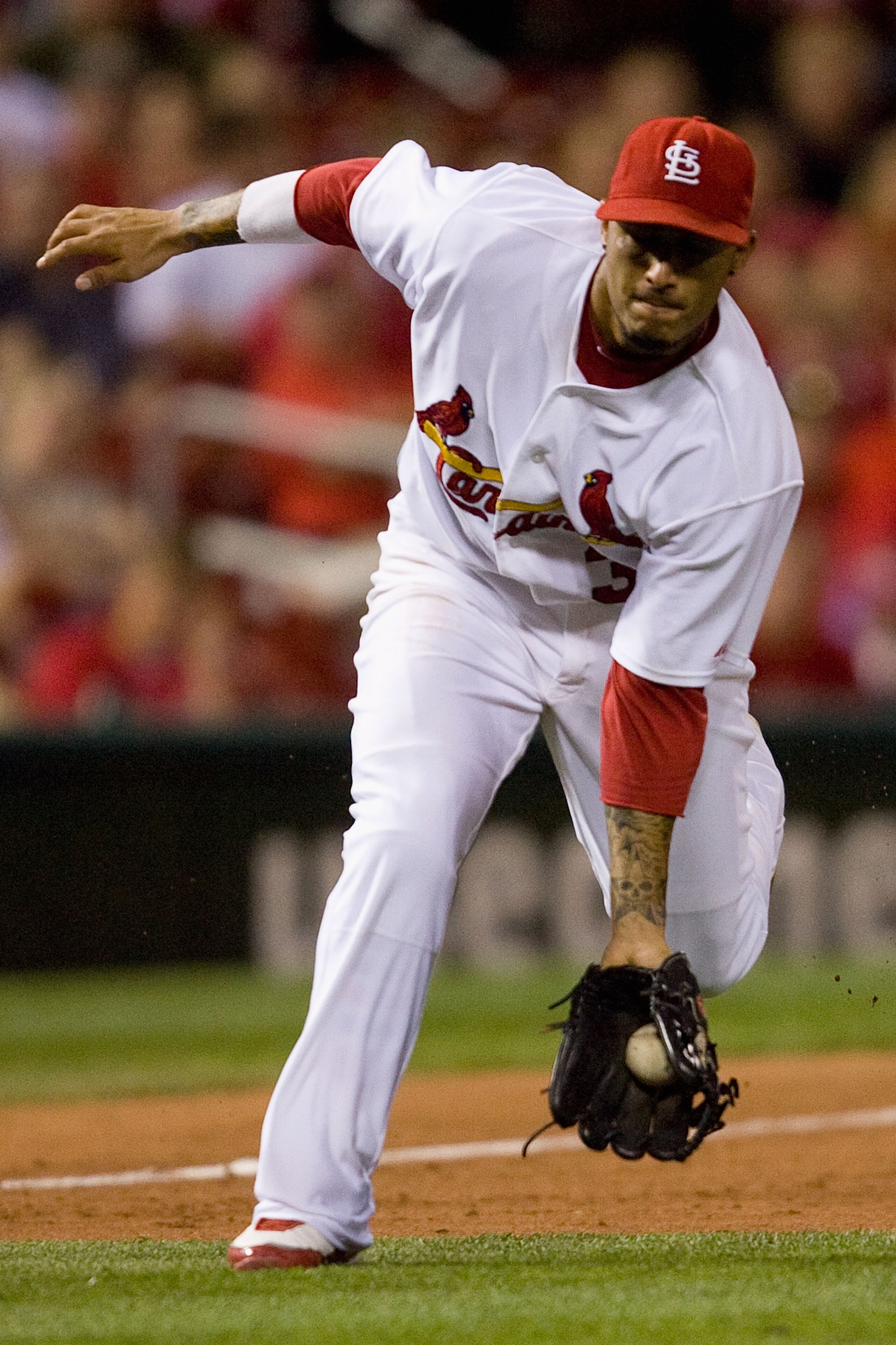 ST. LOUIS - JUNE 28:  Felipe Lopez #3 of the St. Louis Cardinals fields a ground ball against the Arizona Diamondbacks at Busch Stadium on June 28, 2010 in St. Louis, Missouri.  The Cardinals beat the Diamondbacks 6-5 in the bottom of the ninth.  (Photo b