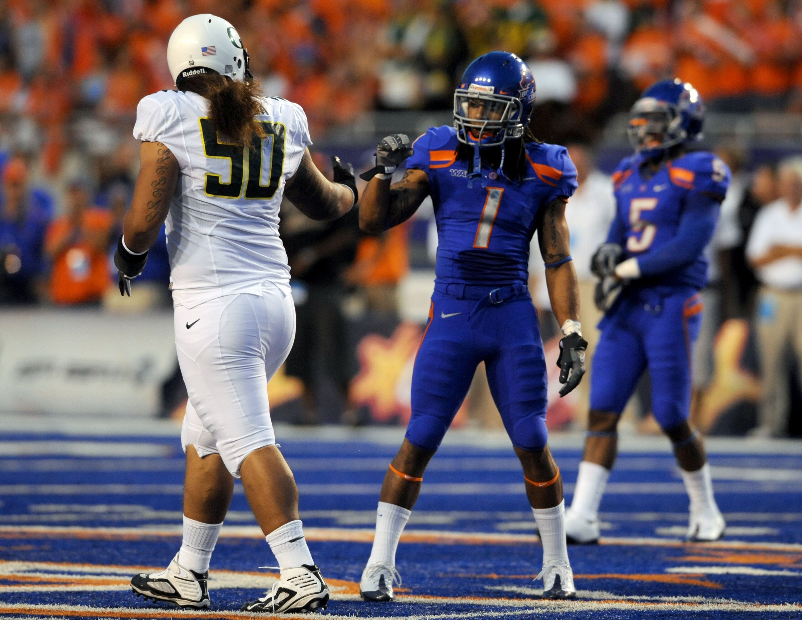 BOISE, ID - SEPTEMBER 3: Defensive tackle Simi Toeaina #50 of the Oregon Ducks bumps fists with cornerback Kyle Wilson #1 of the Boise State Broncos before the game on September 3, 2009 at Bronco Stadium in Boise, Idaho. Boise State won the game 19-8. (Ph