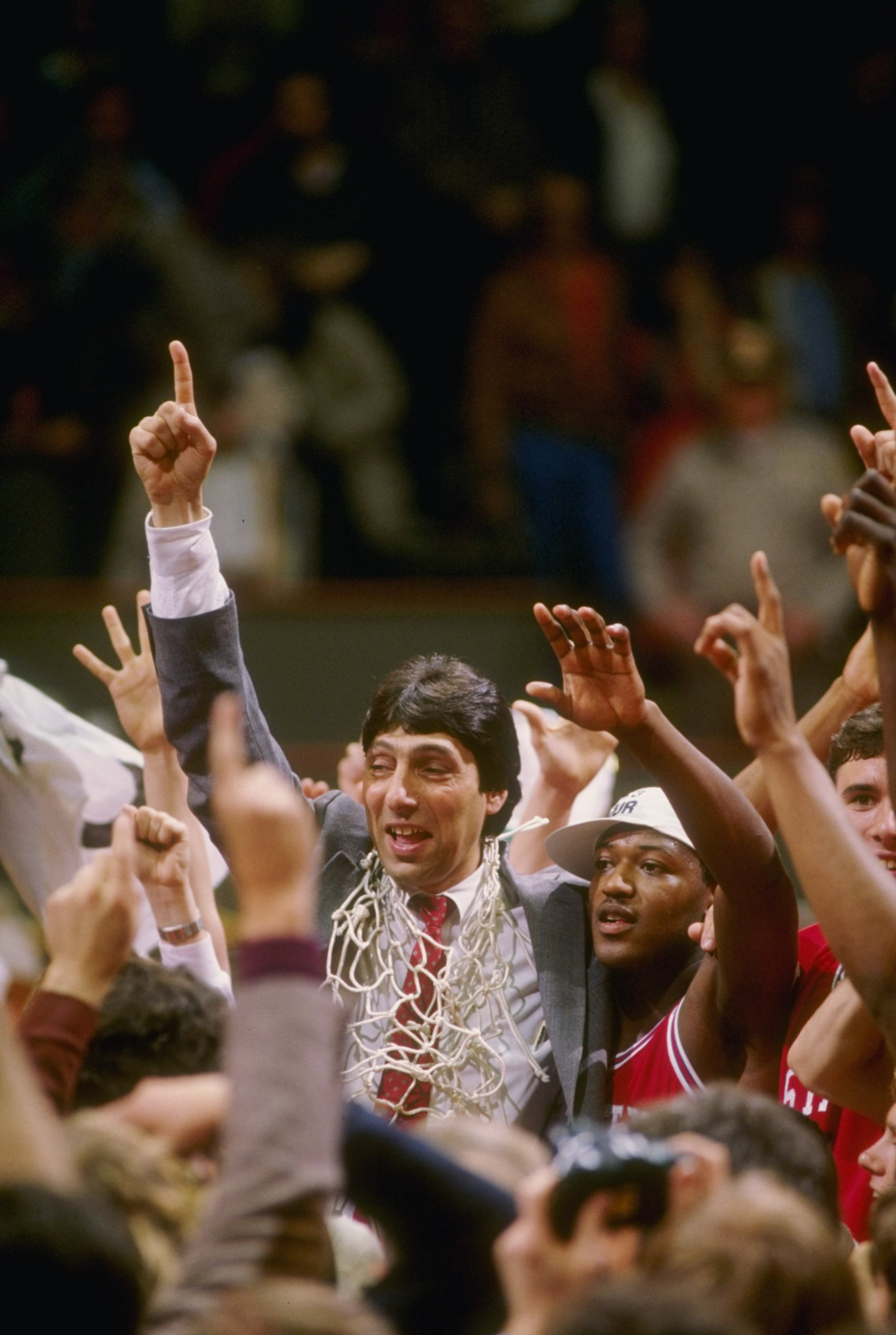 4 Apr 1983: Head coach Jim Valvano of the North Carolina State Wolfpack celebrates with his team after the Wolfpack defeated the Houston Cougars 54-52 in the NCAA men''s basketball championship game at University Arena in Albuquerque, New Mexico. 4 Apr 1983: Head coach Jim Valvano of the North Carolina State Wolfpack celebrates with his team after the Wolfpack defeated the Houston Cougars 54-52 in the NCAA men''s basketball championship game at University Arena in Albuquerque, New Mexico.