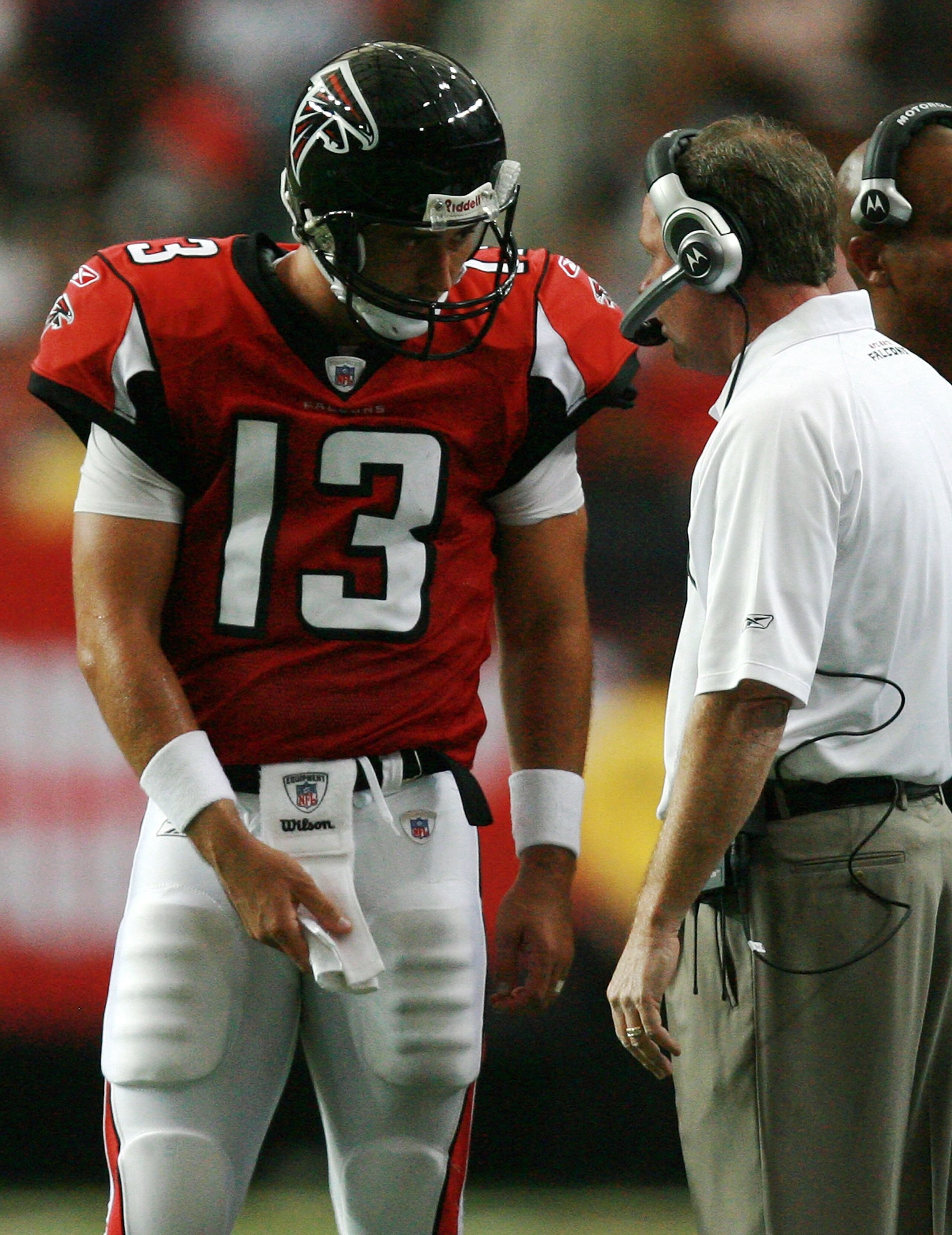 ATLANTA - SEPTEMBER 23:  Quarterback Joey Harrington #13 of the Atlanta Falcons talks with head coach Bobby Petrino on the sidelines while takng on the Carolina Panthers at Georgia Dome on September 23, 2007 in Atlanta, Georgia. The Panthers defeated the