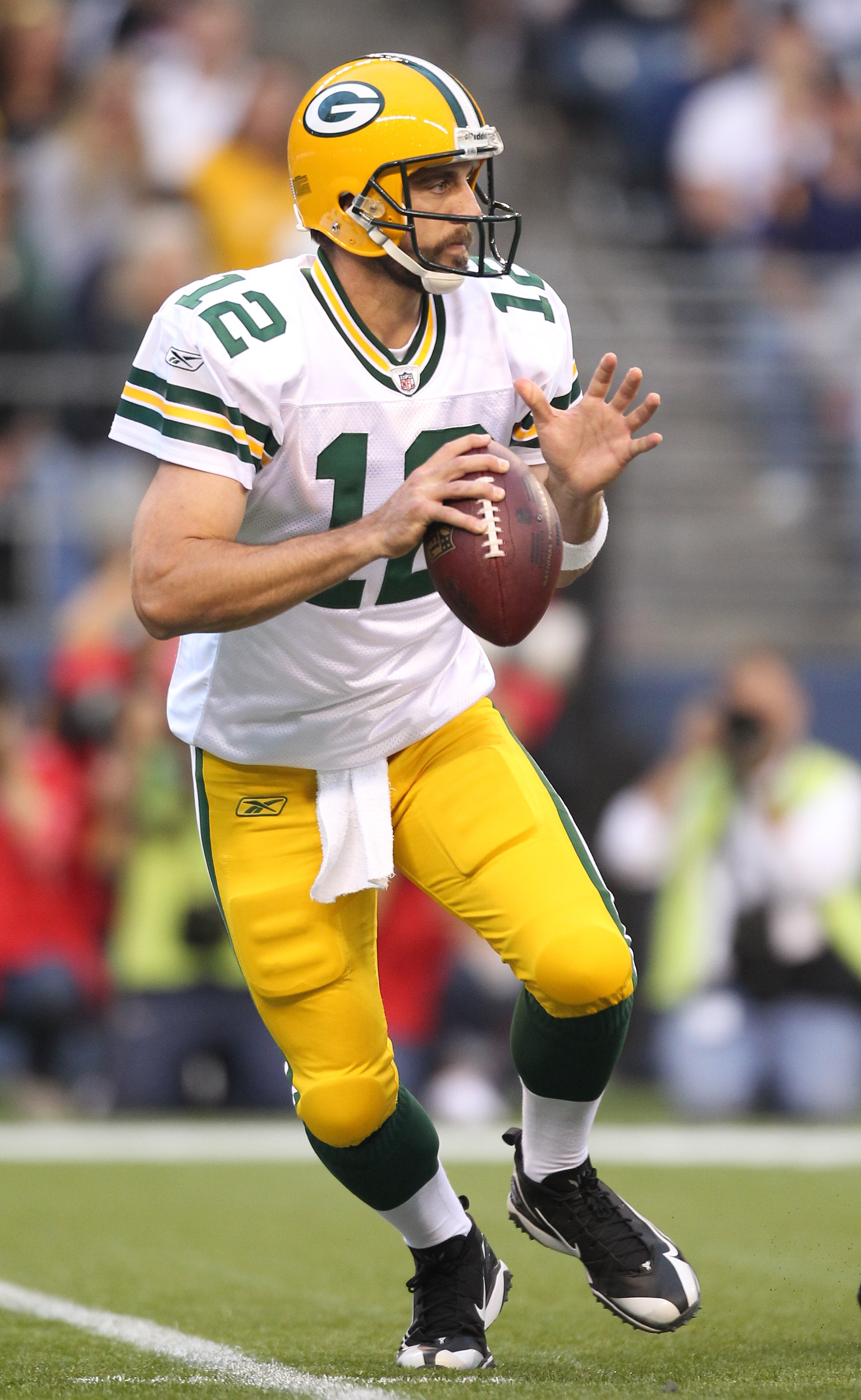 SEATTLE - AUGUST 21:  Quarterback Aaron Rodgers #12 of the Green Bay Packers drops back to pass during the preseason game against the Seattle Seahawks at Qwest Field on August 21, 2010 in Seattle, Washington. (Photo by Otto Greule Jr/Getty Images)