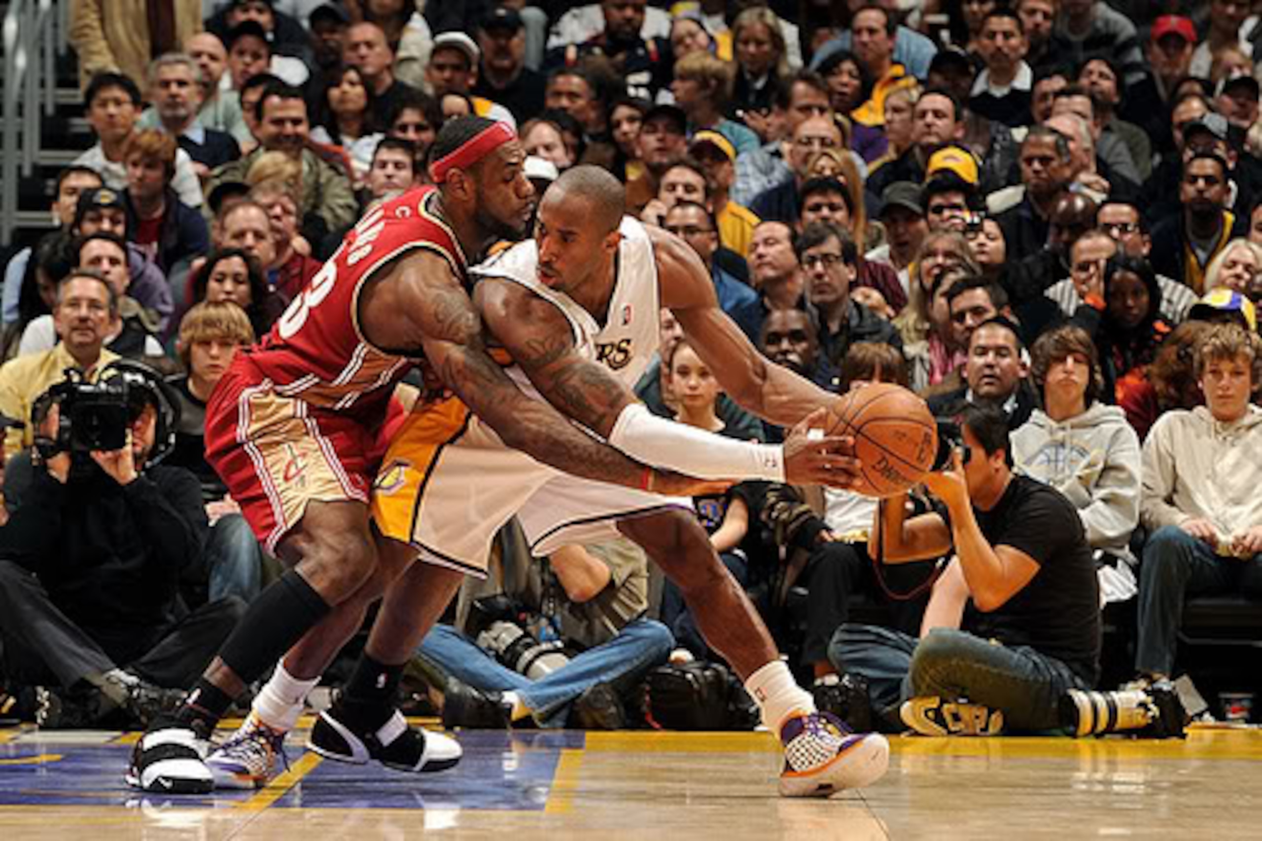 LeBron James trying to check Kobe Bryant