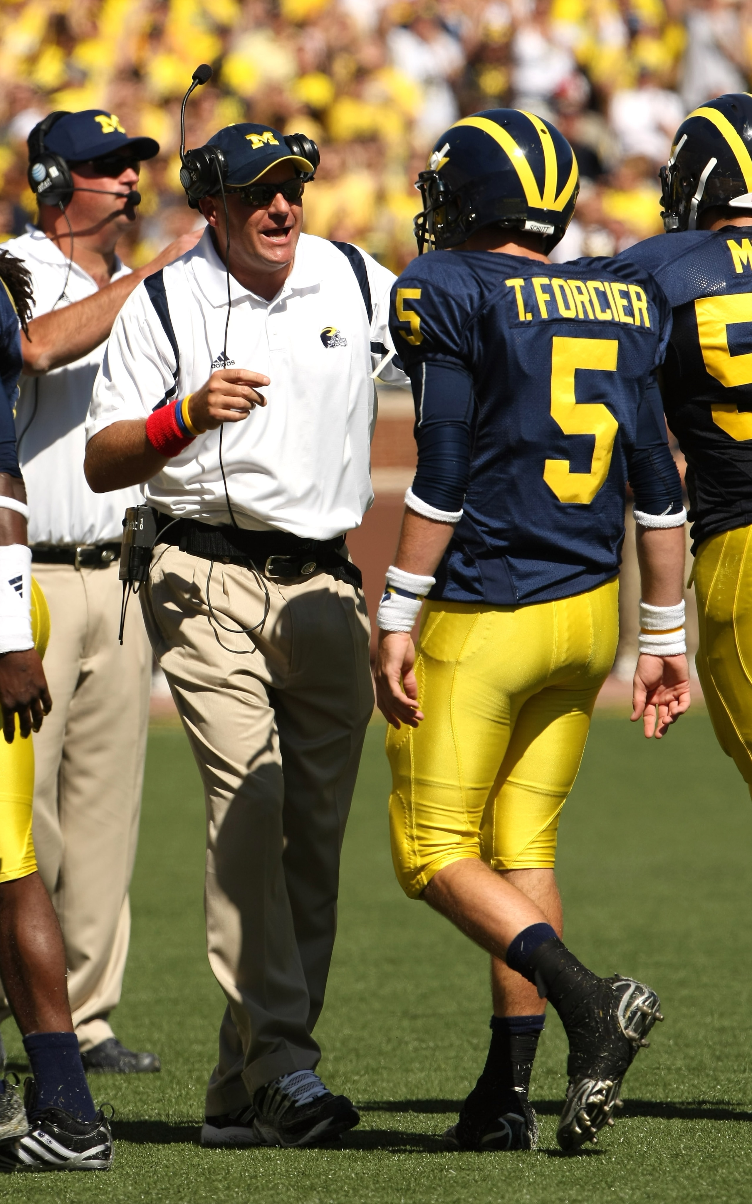 ANN ARBOR, MI - SEPTEMBER 19:  Head coach Rich Rodriguez of the Michigan Wolverines talks with quarterback Tate Forcier #5 during the game with the Eastern Michigan Eagles at Michigan Stadium on September 19, 2009 in Ann Arbor, Michigan.  (Photo by Stephe