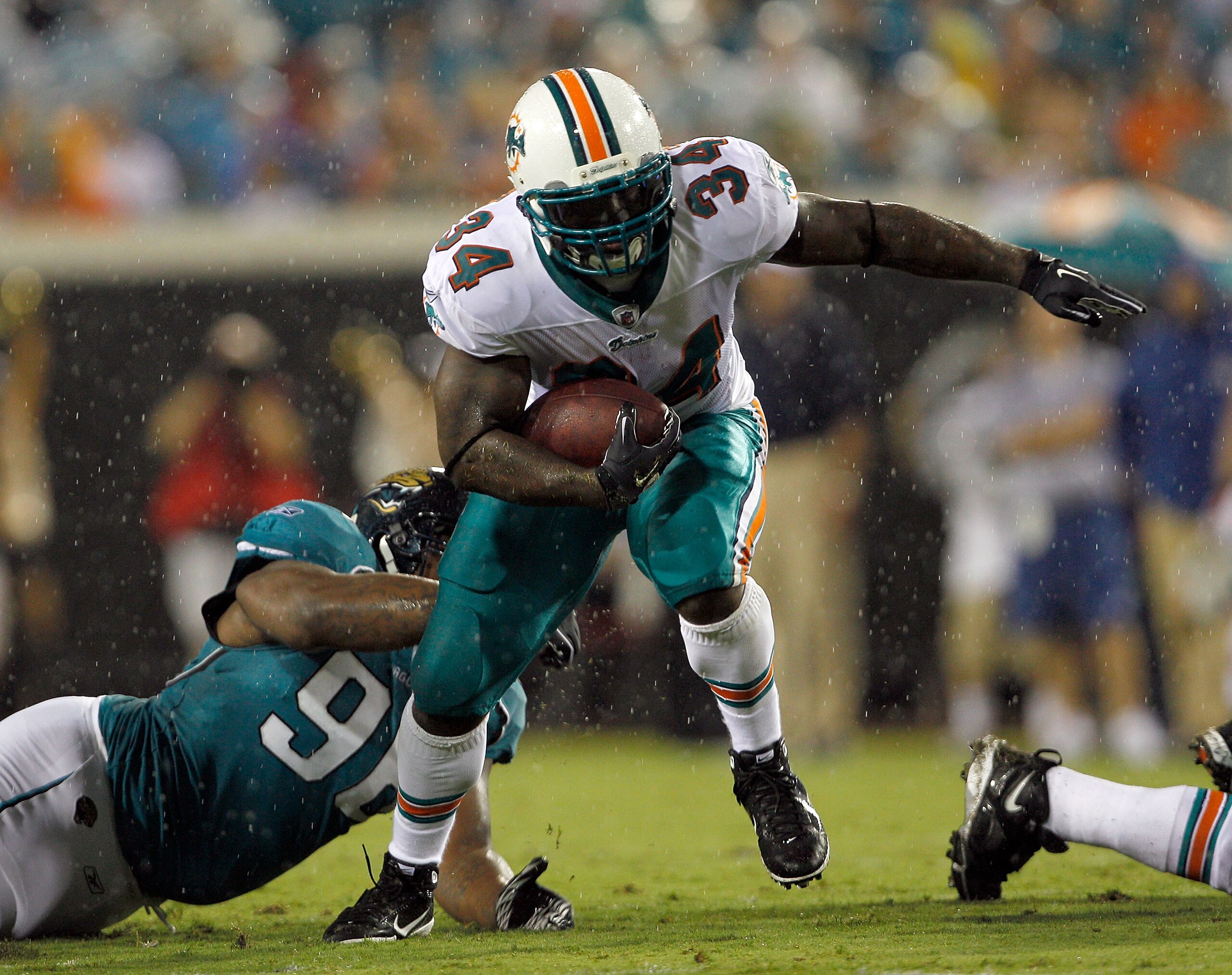 JACKSONVILLE, FL - AUGUST 21:  Terrance Knighton #96 of the Jacksonville Jaguars attempts to tackle Ricky Williams #34 of the Miami Dolphins during the preseason game at EverBank Field on August 21, 2010 in Jacksonville, Florida.  (Photo by Sam Greenwood/