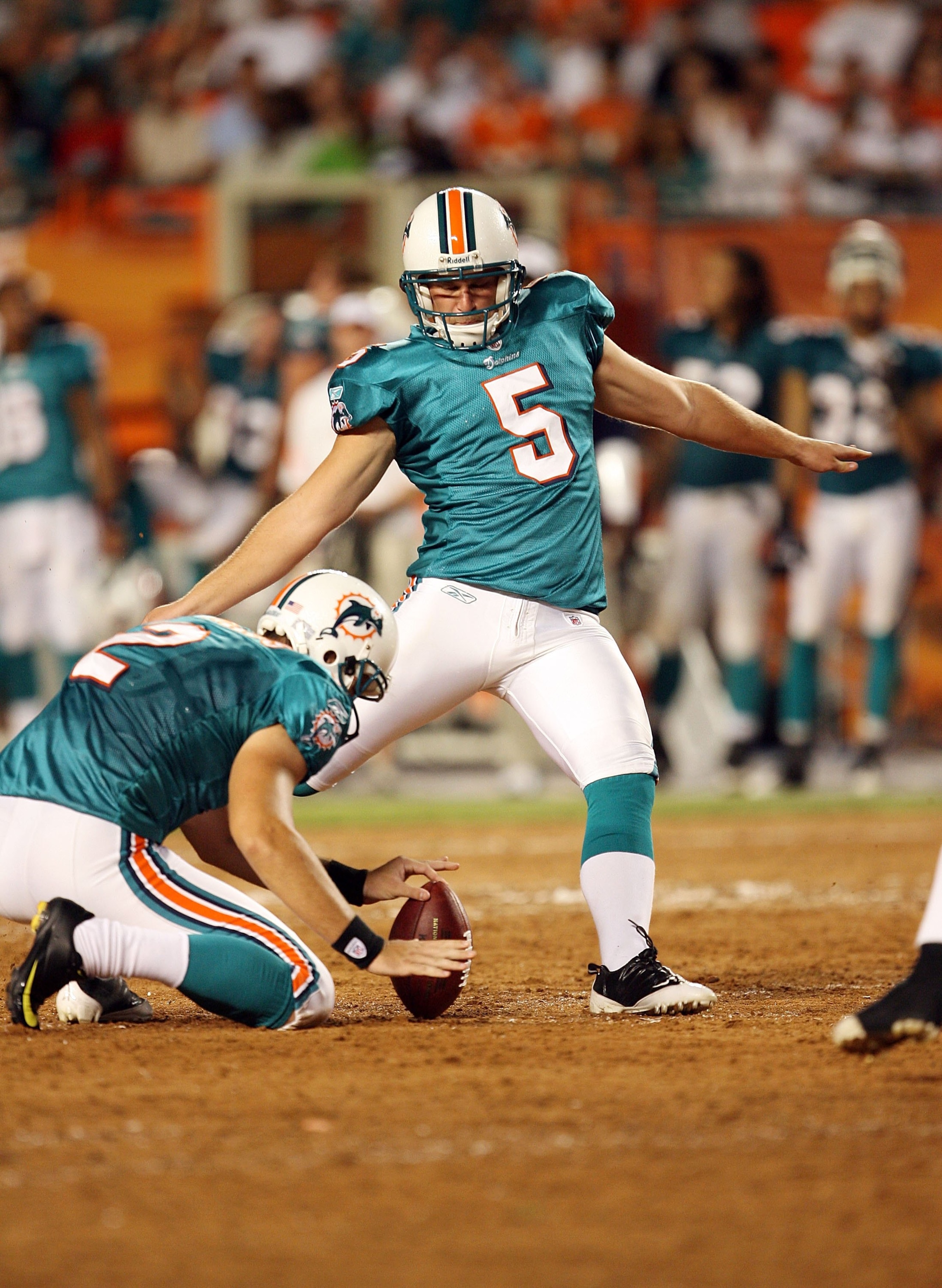 MIAMI - SEPTEMBER 21:  Place kicker Dan Carpenter #5 of the Miami Dolphins kicks a field goal out from under the hold of punter Brandon Fields #2 while taking on the Indianapolis Colts at Land Shark Stadium on September 21, 2009 in Miami, Florida. The Col