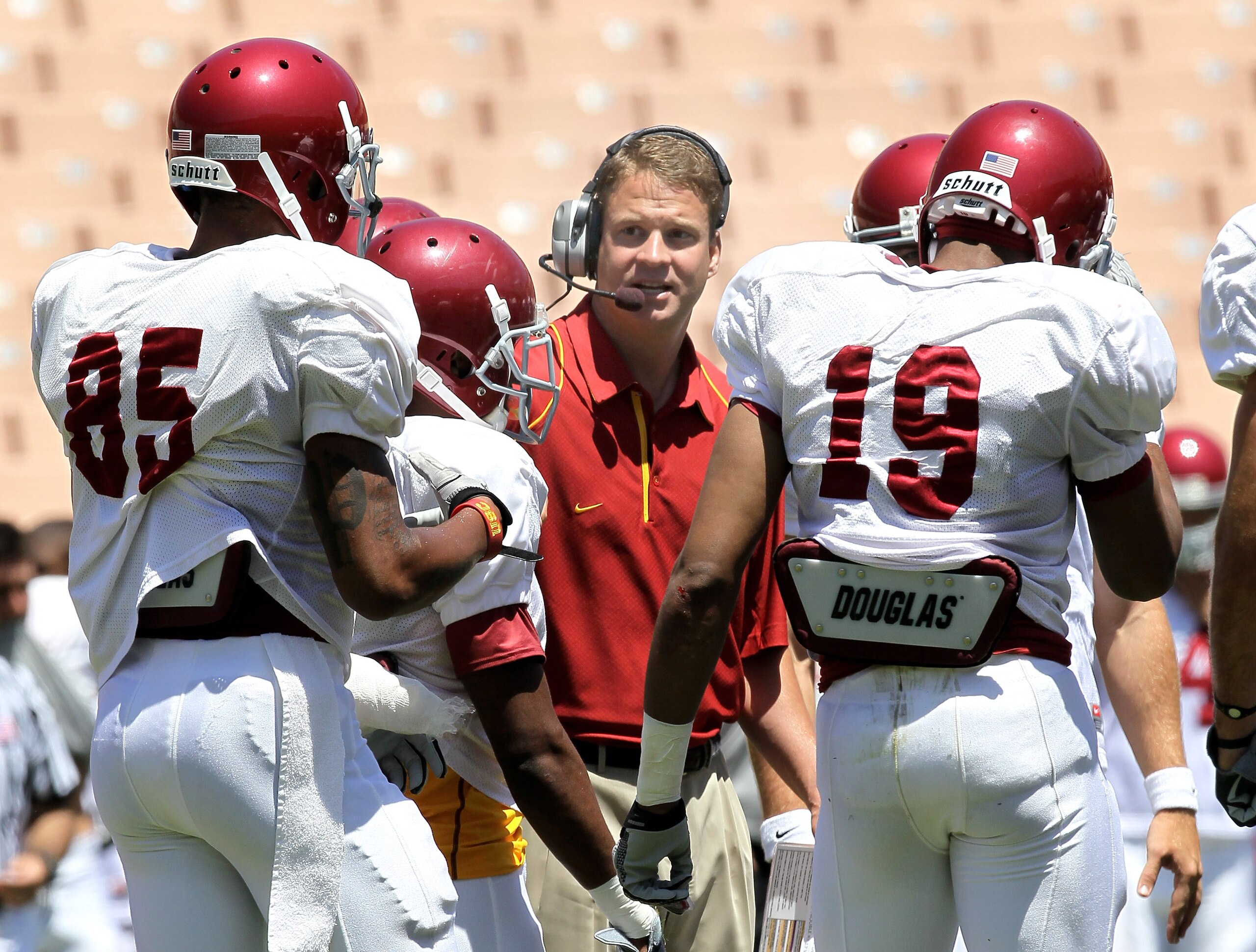 LOS ANGELES, CA - MAY 01:  Head coach Lane Kiffin gives instructions in the offensive huddle during the  USC Trojans spring game on  May 1, 2010 at the Los Angeles Memorial Coliseum in Los Angeles, California.  (Photo by Stephen Dunn/Getty Images)