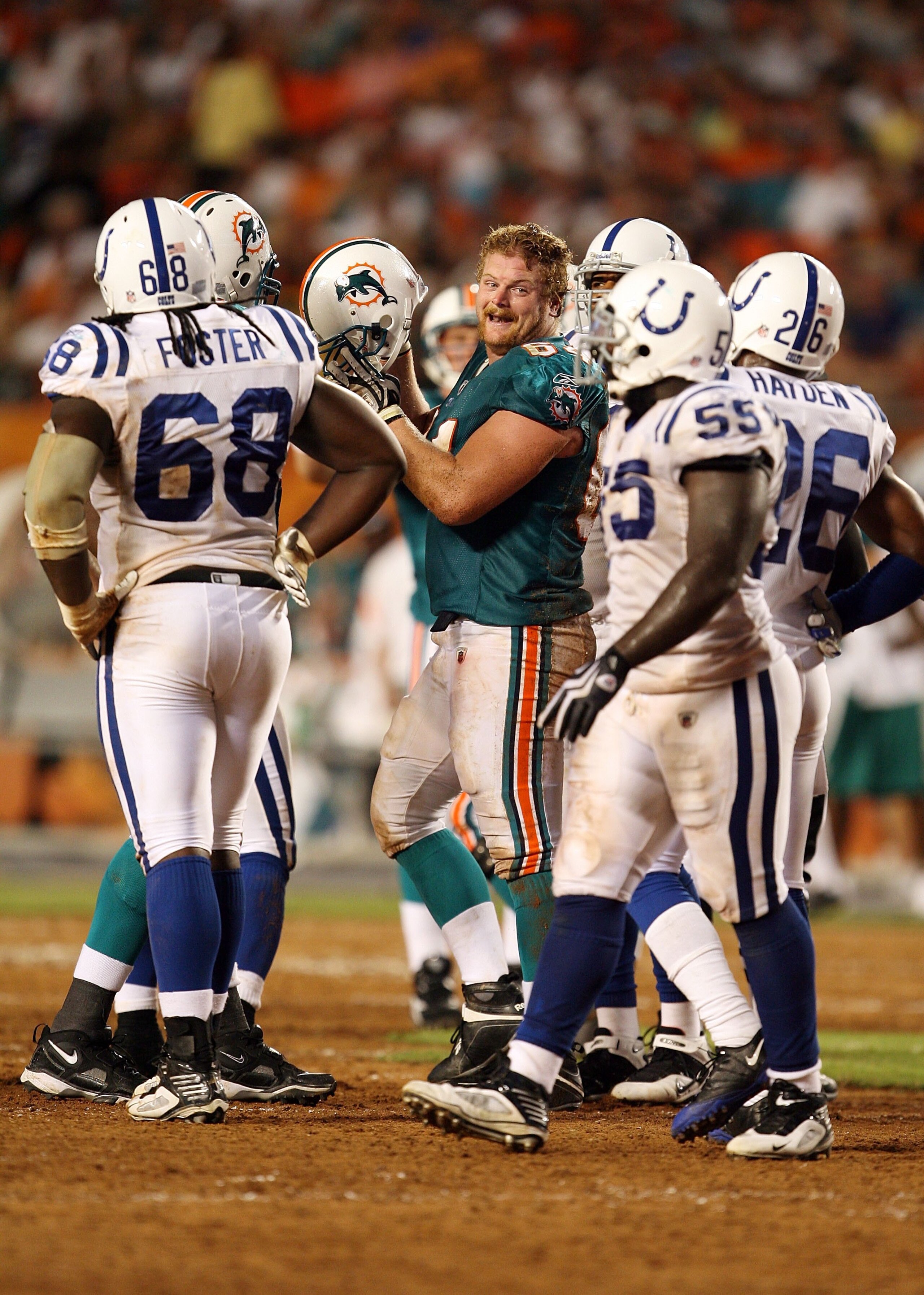 MIAMI - SEPTEMBER 21:  Center Jake Grove #64 of the Miami Dolphins yells back to defensive back Kelvin Hayden #26 of the Indianapolis Colts after having his helmet knocked off during a play at Land Shark Stadium on September 21, 2009 in Miami, Florida. Th