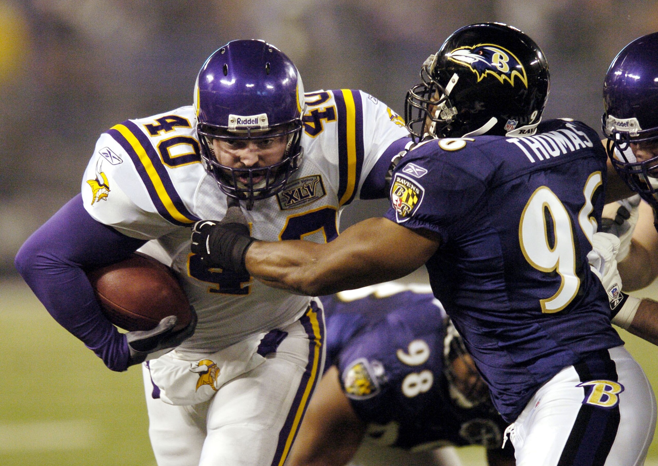 BALTIMORE - DECEMBER 25:  Jim Kleinsasser #40 of the Minnesota Vikings runs into Adalius Thomas #96 of the Baltimore Ravens during the second quarter on December 25, 2005 M&T Bank Stadium in Baltimore, Maryland. The Ravens won 30-23.  (Photo by Nick Wass/