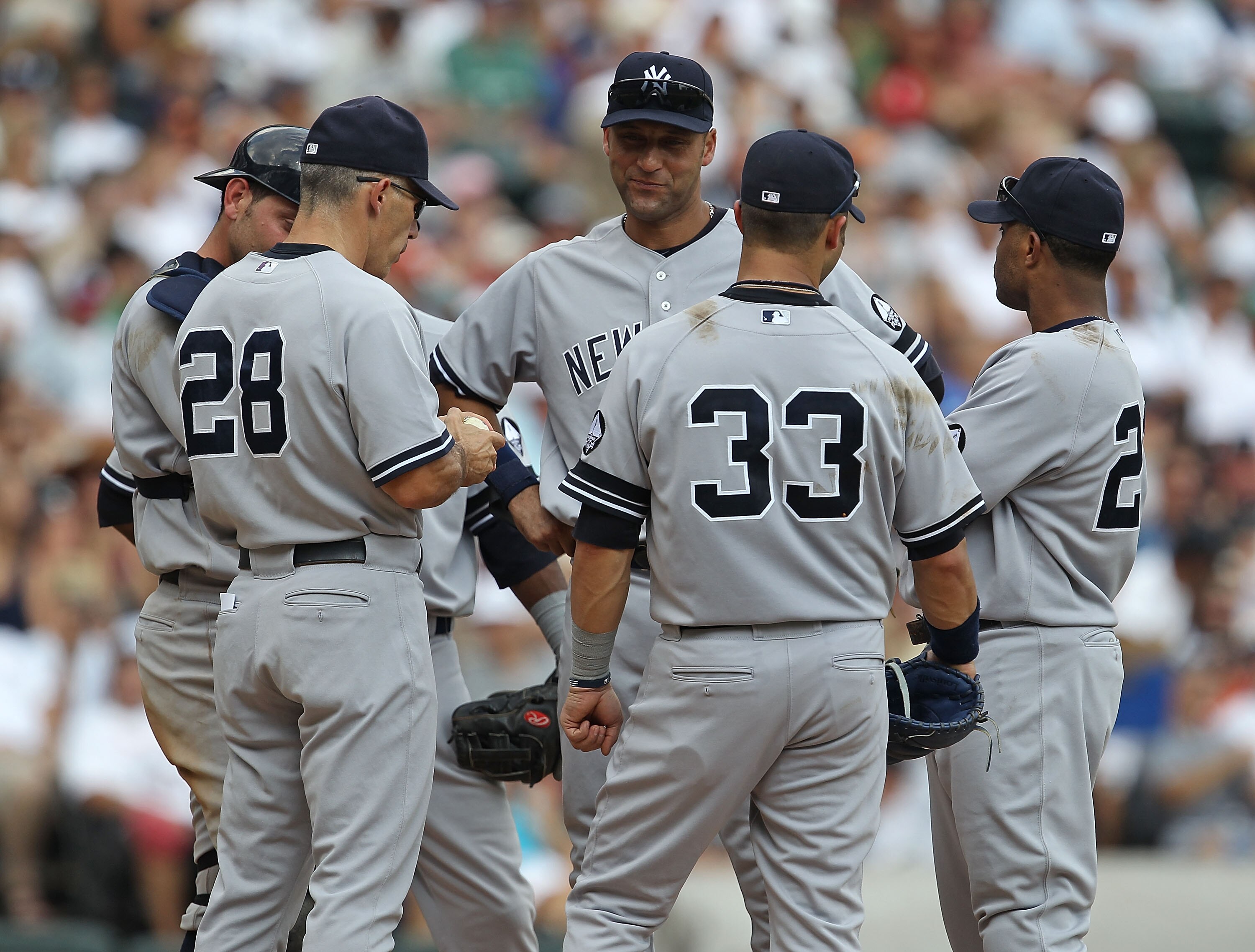 CHICAGO - AUGUST 29: Manager Joe Girardi #28 of the New York Yankees talks with (L-R) Francisco Cervelli #29, Derek Jeter #2, Nick Swisher #33 and Robinson Cano #24 at the mound during a pitching change against the Chicago White Sox at U.S. Cellular Field