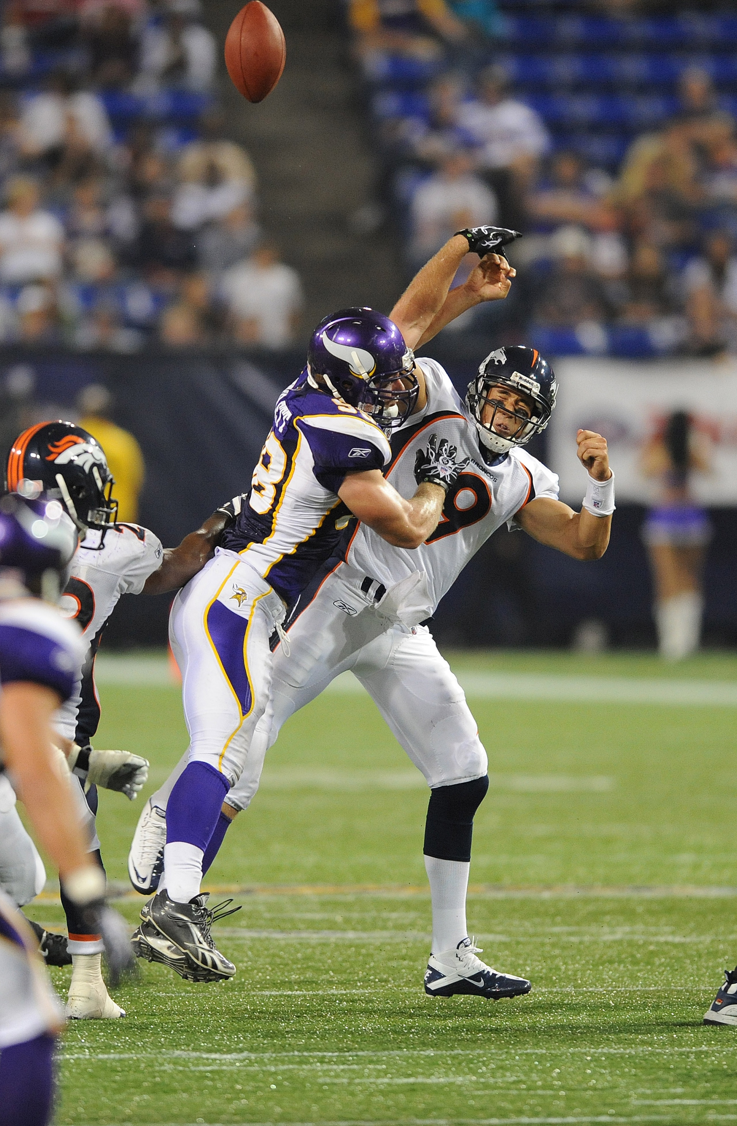 MINNEAPOLIS - SEPTEMBER 02:  Brady Quinn #9 of the Denver Broncos passes the ball as Nate Triplett #58 of the Minnesota Vikings defends during an NFL preseason game at the Mall of America Field at Hubert H. Humphrey Metrodome, on September 2, 2010 in Minn