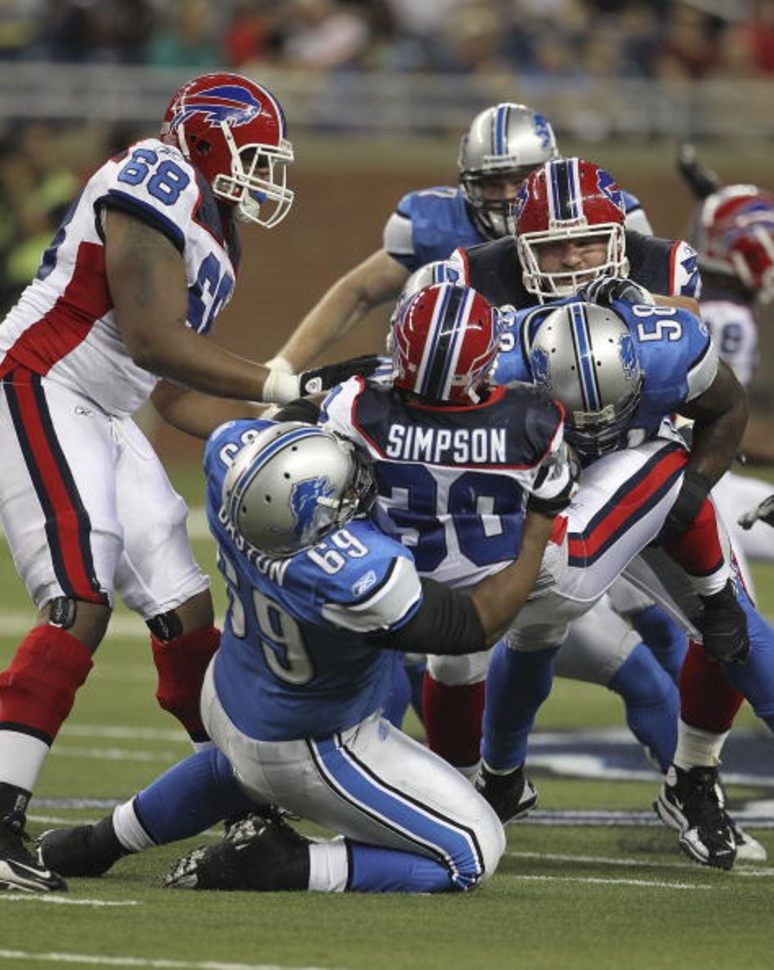 DETROIT - SEPTEMBER 02: Jaron Baston #69 and Ashlee Palmer #58 of the Detroit Lions make the stop on Chad Simpson #30 of the Buffalo Bills during the preseason game at Ford Field on September 2, 2010 in Detroit, Michigan.  (Photo by Leon Halip/Getty Image