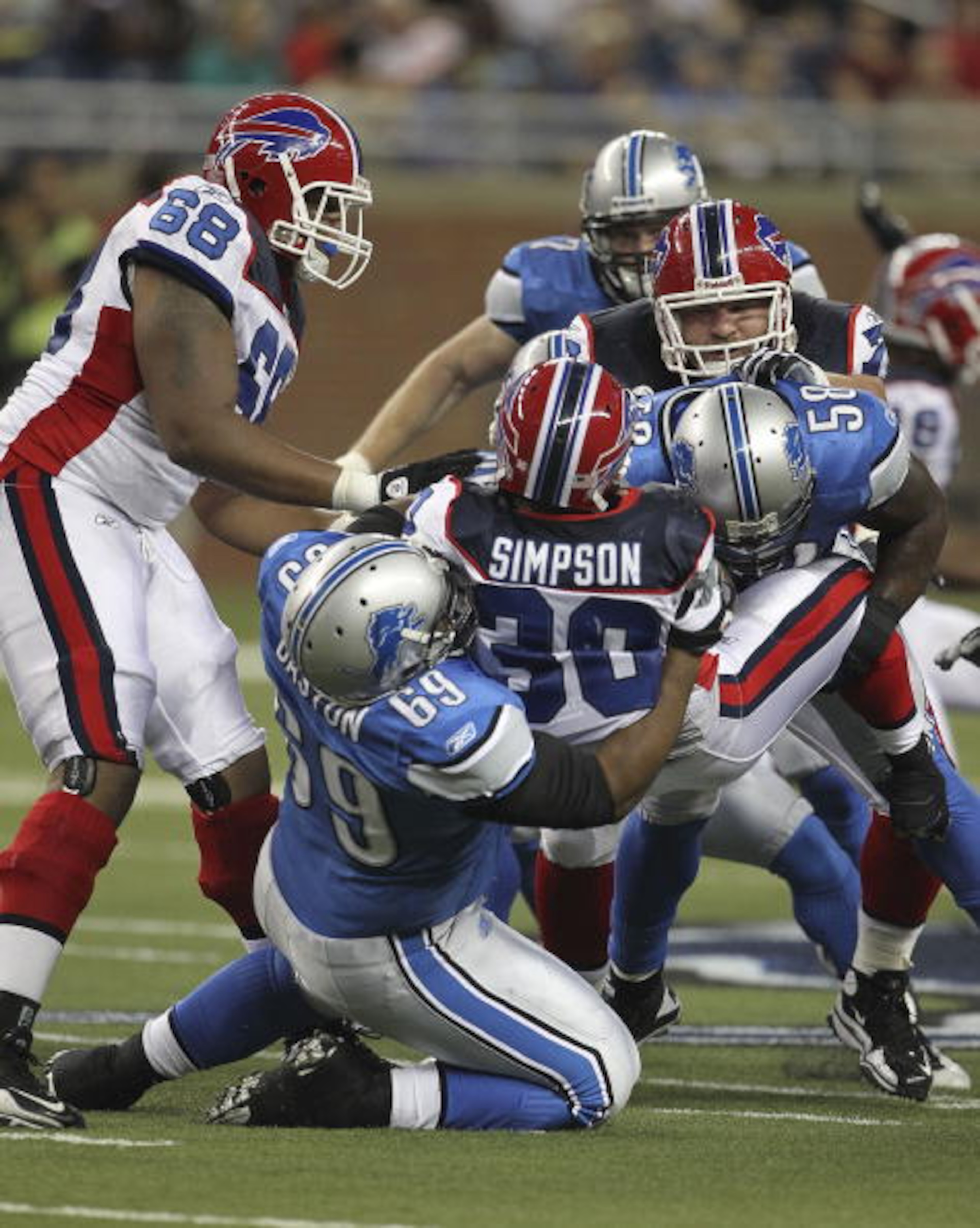 DETROIT - SEPTEMBER 02: Jaron Baston #69 and Ashlee Palmer #58 of the Detroit Lions make the stop on Chad Simpson #30 of the Buffalo Bills during the preseason game at Ford Field on September 2, 2010 in Detroit, Michigan.  (Photo by Leon Halip/Getty Image