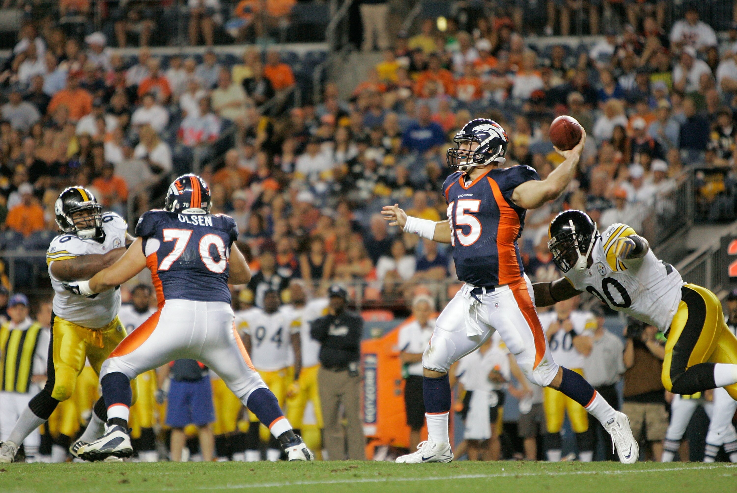 DENVER - AUGUST 29:  Quarterback Tim Tebow #15 of the Denver Broncos makes a pass against the Pittsburgh Steelers and avoids a sack by linebacker Thaddeus Gibson #90 at INVESCO Field at Mile High on August 29, 2010 in Denver, Colorado.  (Photo by Justin E