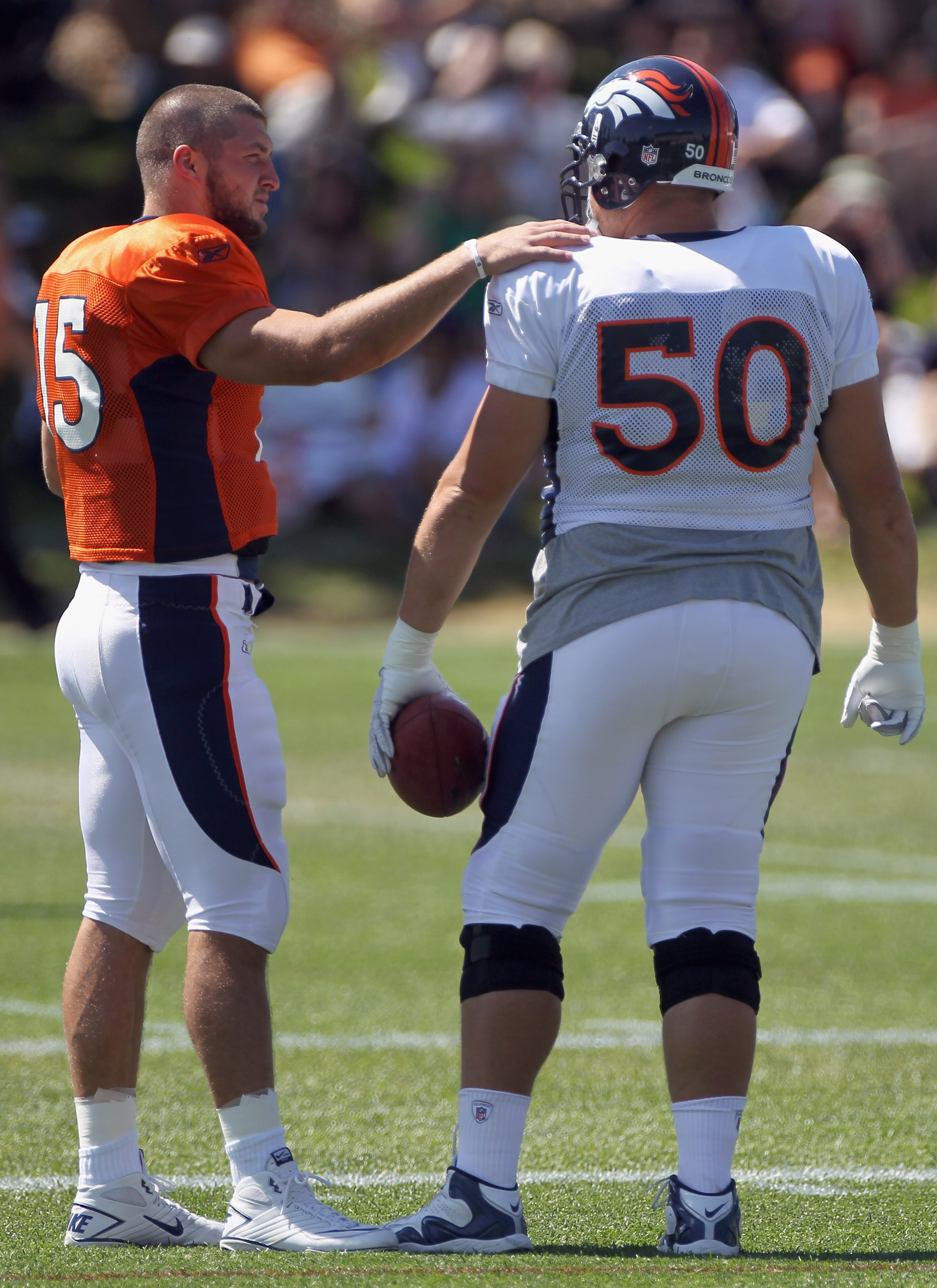 ENGLEWOOD, CO - AUGUST 18: Rookie quarterback Tim Tebow #15 of the Denver Broncos talks with rookie offensive lineman J D Walton #50 during training camp practice at Dove Valley on August 18, 2010 in Englewood, Colorado. (Photo by Doug Pensinger/Getty I ENGLEWOOD, CO - AUGUST 18: Rookie quarterback Tim Tebow #15 of the Denver Broncos talks with rookie offensive lineman J D Walton #50 during training camp practice at Dove Valley on August 18, 2010 in Englewood, Colorado. (Photo by Doug Pensinger/Getty I