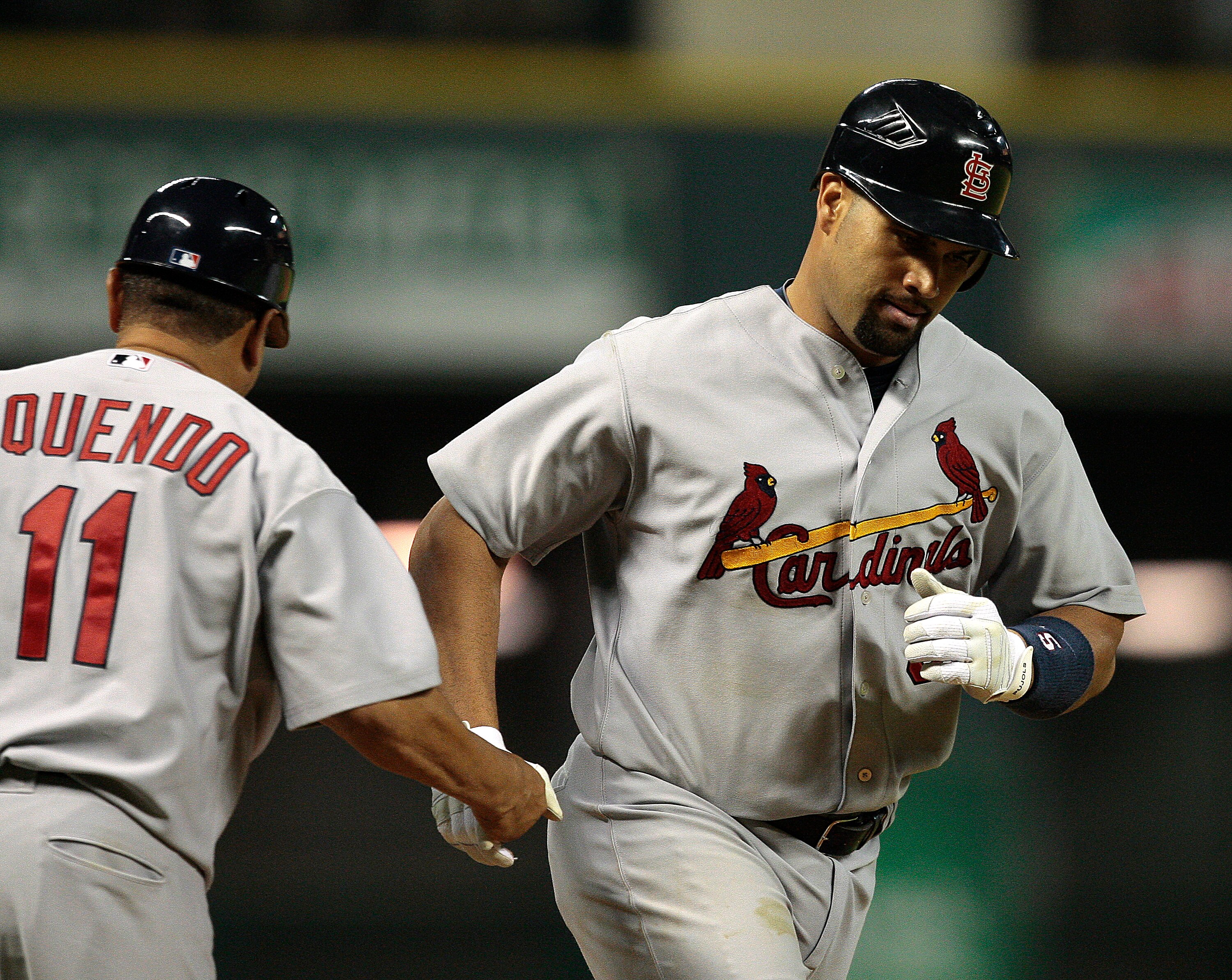 HOUSTON - JULY 09:  Albert Pujols #5 of the St. Louis Cardinals is congratulated by third base coach Jose Oquendo #11 after hitting a three-run home run in the ninth inning against the Houston Astros at Minute Maid Park on July 9, 2010 in Houston, Texas.