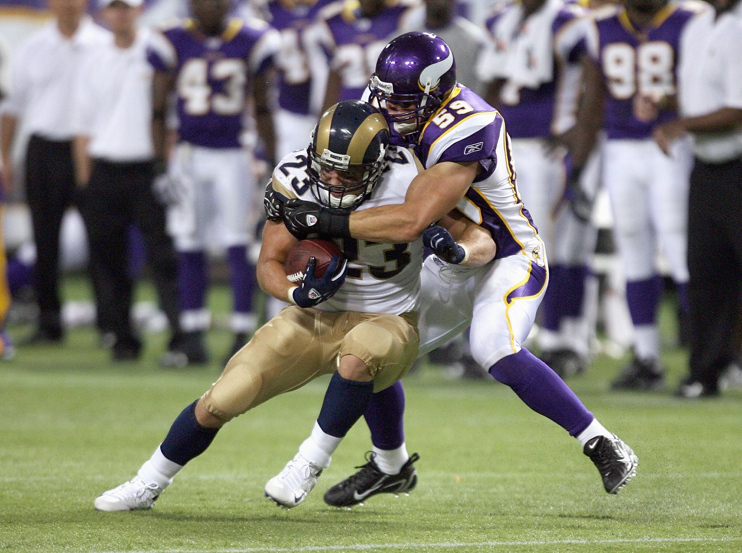 MINNEAPOLIS - AUGUST 10: Brian Leonard #23 of the St. Louis Rams is tackled by linebacker Heath Farwell #59 of the Minnesota Vikings on August 10, 2007 at the H.H.H. Metrodome in Minneapolis, Minnesota. (Photo by David Sherman/Getty Images)