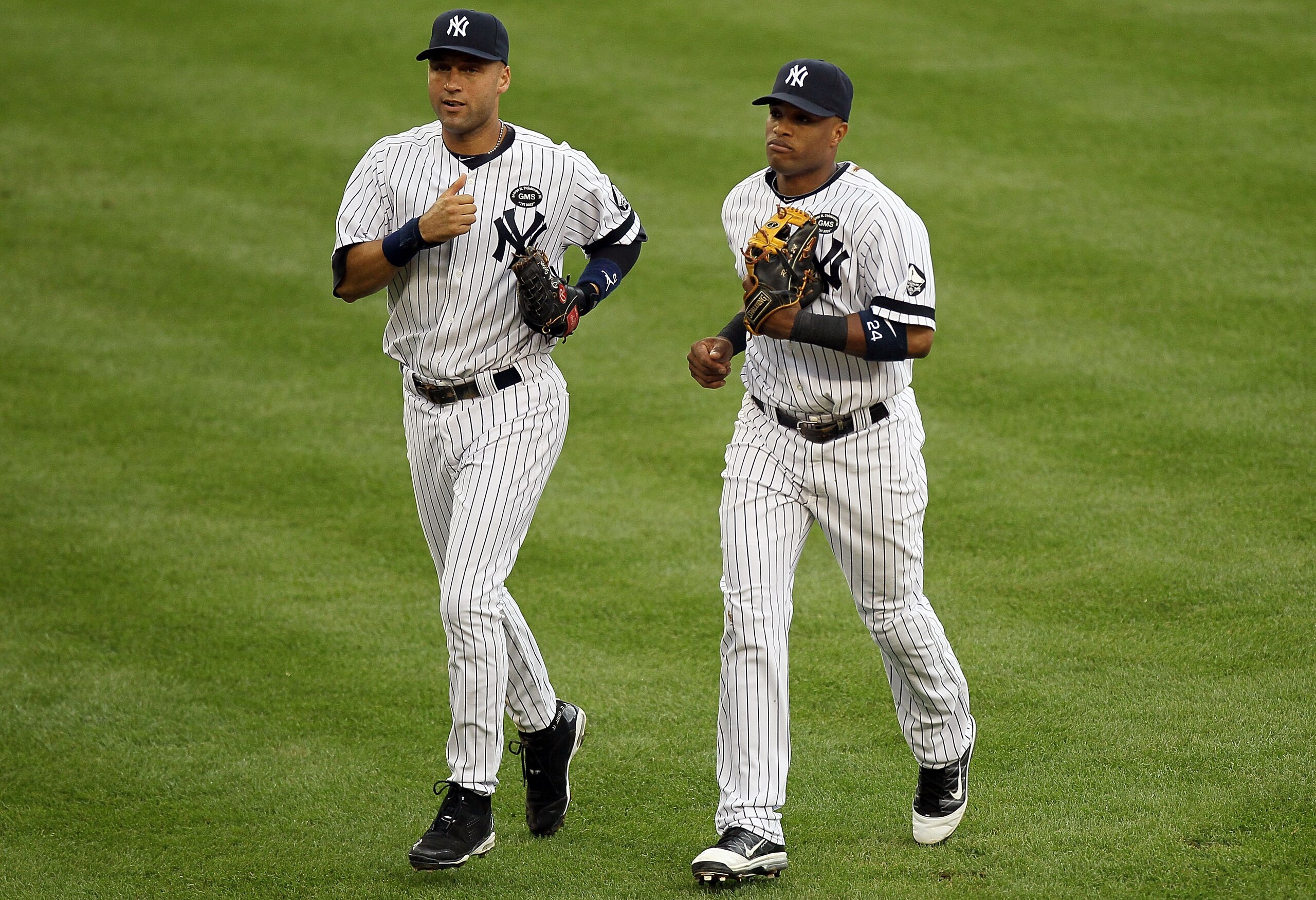 NEW YORK - AUGUST 22:  Derek Jeter #2 and Robinson Cano #24 of the New York Yankees run off the field after an inning against the Seattle Mariners on August 22, 2010 at Yankee Stadium in the Bronx borough of New York City.  (Photo by Jim McIsaac/Getty Ima