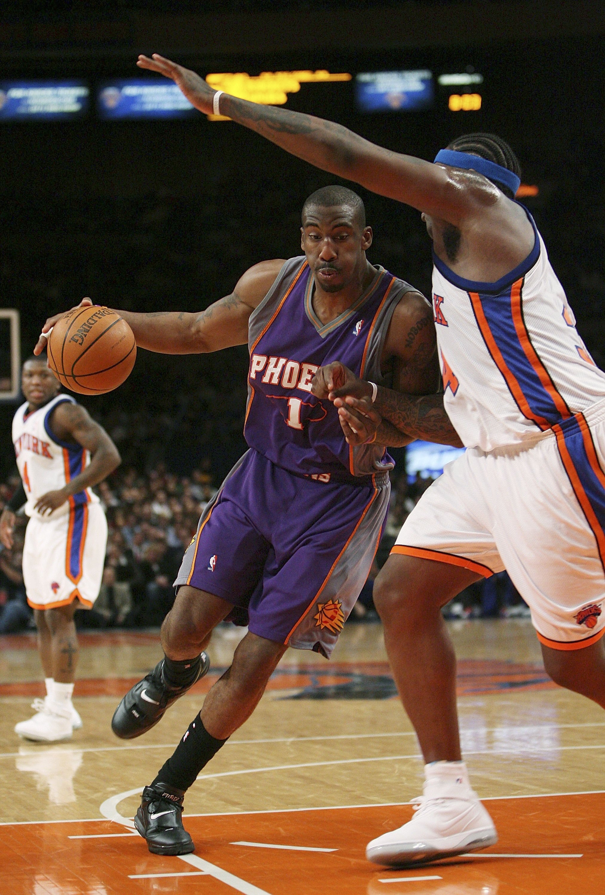 NEW YORK - JANUARY 24:  Amare Stoudemire #1 of the Phoenix Suns drives against Eddy Curry #34 of the New York Knicks January 24, 2007 at Madison Square Garden in New York City. NOTE TO USER: User expressly acknowledges and agrees that, by downloading and 