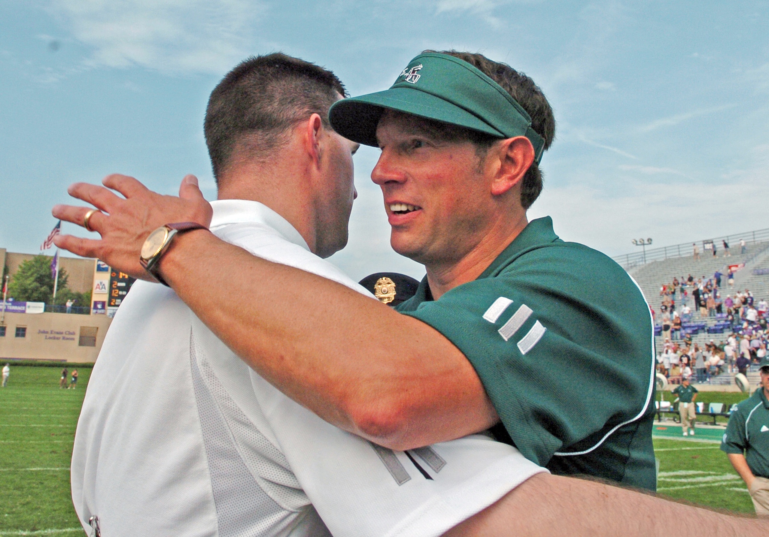 Northwestern coach Pat Fitzgerald hugs Eastern Michigan coach Jeff Genyk September 16, 2006 at Evanston.  The Wildcats won 14 - 6. (Photo by A. Messerschmidt/Getty Images) *** Local Caption ***