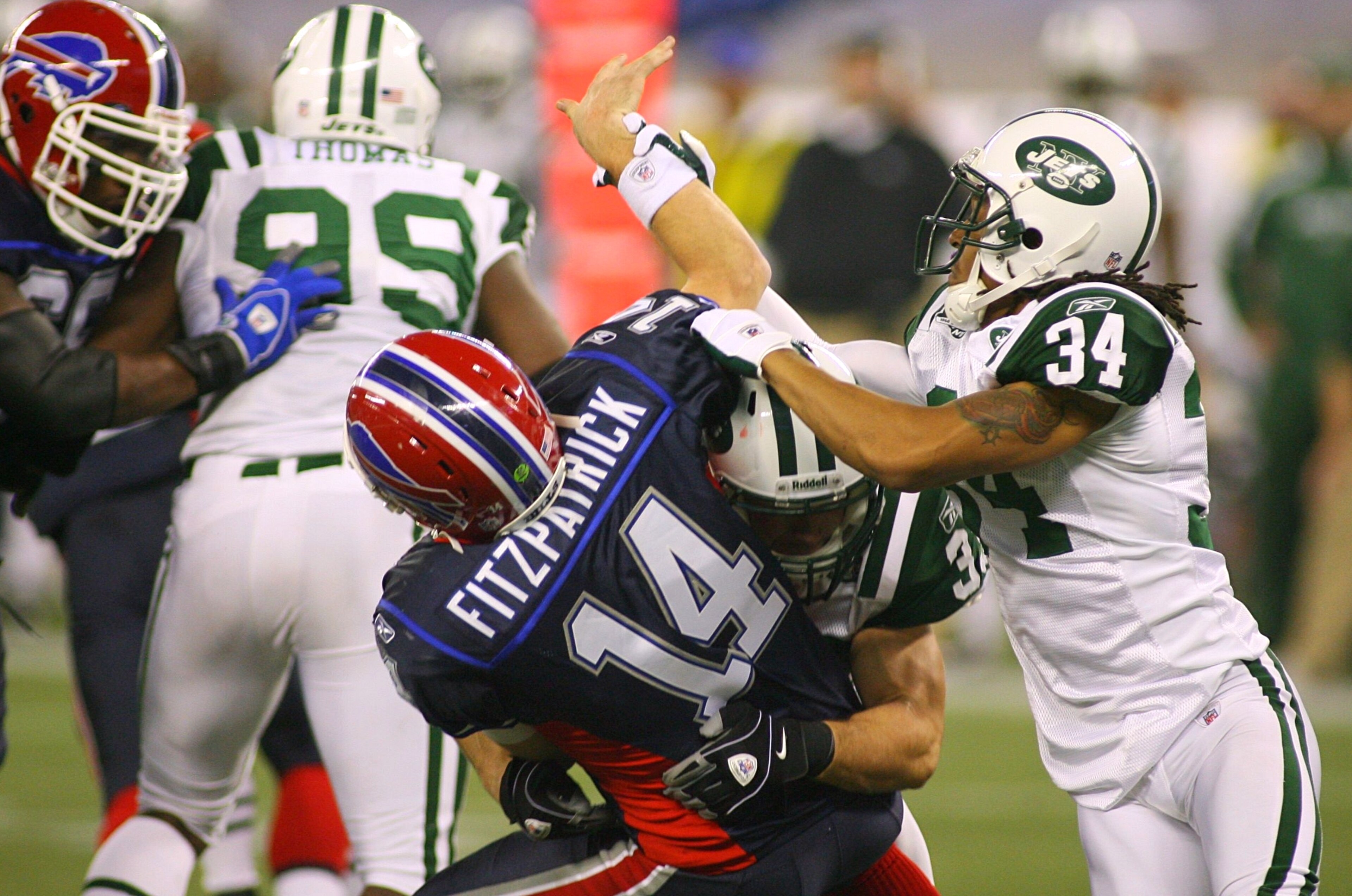 TORONTO - DECEMBER 3: Eric Smith #33 and Marquice Cole #34 of the New York Jets hit quarterback Ryan Fitzpatrick #14 of the Buffalo Bills as he throws the ball at Rogers Centre on December 3, 2009 in Toronto, Canada. (Photo by Rick Stewart/Getty Images) TORONTO - DECEMBER 3: Eric Smith #33 and Marquice Cole #34 of the New York Jets hit quarterback Ryan Fitzpatrick #14 of the Buffalo Bills as he throws the ball at Rogers Centre on December 3, 2009 in Toronto, Canada. (Photo by Rick Stewart/Getty Images)